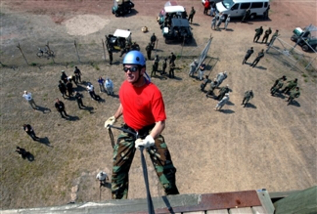 Dan Simons, a participant from the 75th Joint Civilian Orientation Conference, rappels off a training wall at Soto Cano Air Base, Honduras, April 24, 2008. About 50 JCOC participants visited five countries, three forward operating locations, two naval bases and a Navy carrier in U.S. Southern Command's area of responsibility.
.  




