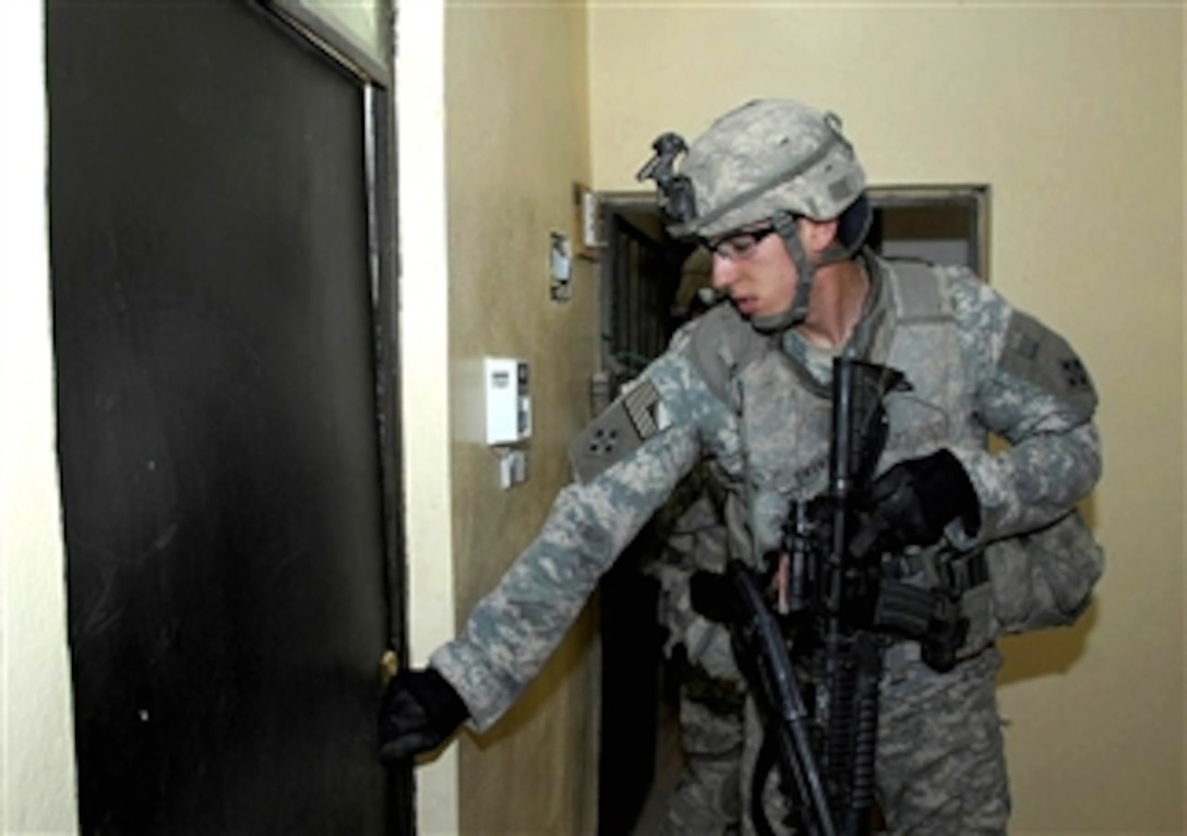 A U.S. Army soldier prepares to clear a room during a search for weapons and bomb paraphernalia in the town of Younis Al Sabawi, Mosul, Iraq, on April 16, 2008. The soldiers are assigned to the 4th Infantry Division's 3rd Brigade Combat Team.  
