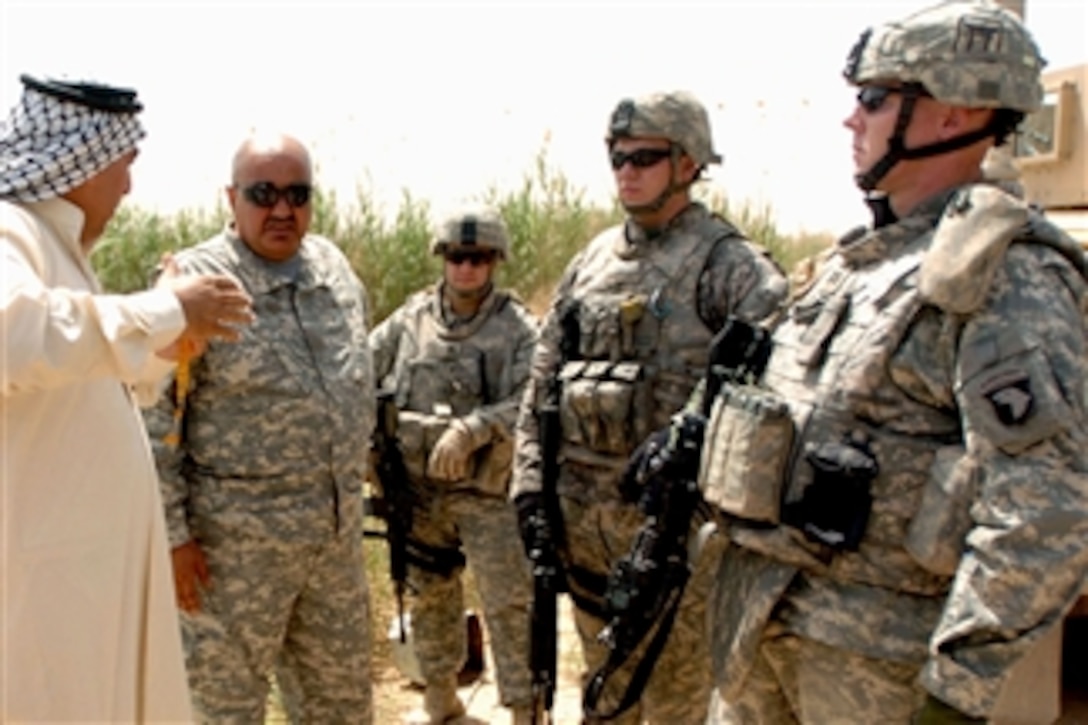 U.S. Army soldiers speak with a fish farmer in the Lutifyah area of Iraq to check the progress of fish ponds there, April 23, 2008. The soldiers are assigned to the 101st Airborne Division's 3rd Brigade Combat Team, 320th Field Artillery Regiment.