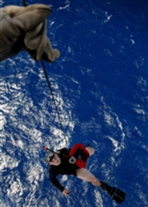 U.S. Navy Petty Officer 3rd Class Justin Sherman dangles over the Pacific Ocean as he is hoisted back into an SH-60B Seahawk helicopter on April 22, 2008.  Sherman is a Navy aviation warfare systems operator and a search and rescue swimmer assigned to Helicopter Antisubmarine Squadron Light 47 deployed onboard the aircraft carrier USS Abraham Lincoln (CVN 72).  