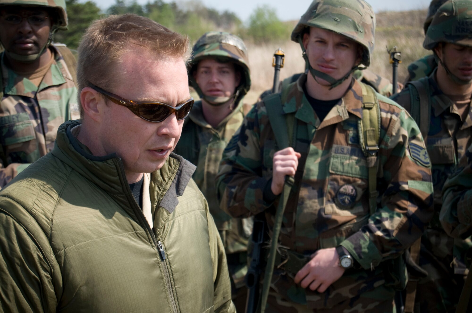 MISAWA AIR BASE, Japan -- Analyst Donnie Hayes, ANSER Analytic Services Inc., debriefs a group of Airmen at Camp Defender on April 25, 2008. The debrief followed the infamous "third day" of Expeditionary Combat Skills Training where the Airmen applied their classroom instruction to field exercises designed to simulate real wartime scenarios. (U.S. Air Force photo by Senior Airman Samuel Morse)