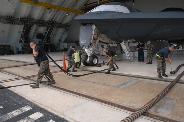 ANDERSEN AIR FORCE BASE, Guam -- A B-2 Spirit stealth bomber is unhooked from aerospace ground equipment by a maintenance team supporting the remaining B-2 Spirits at Andersen AFB. The equipment provides the jet’s power supply while the team performs weekly checks to ensure the B-2 Spirit bomber stays at a mission-ready status. This requires lots of hard work and a huge team effort by all maintainers working on the multi-role stealth bomber. The B-2s here have remained suspended pending the results from a safety investigation board following the first-ever crash of a stealth bomber Feb. 23 here, at Andersen AFB.  The Maintainers are from the 36th Expeditionary Aircraft Maintenance Squadron and are deployed from the 509th Bomb Wing, Whiteman, AFB, Mo. (U.S. Air Force photo by Staff Sgt. Vanessa Valentine)
