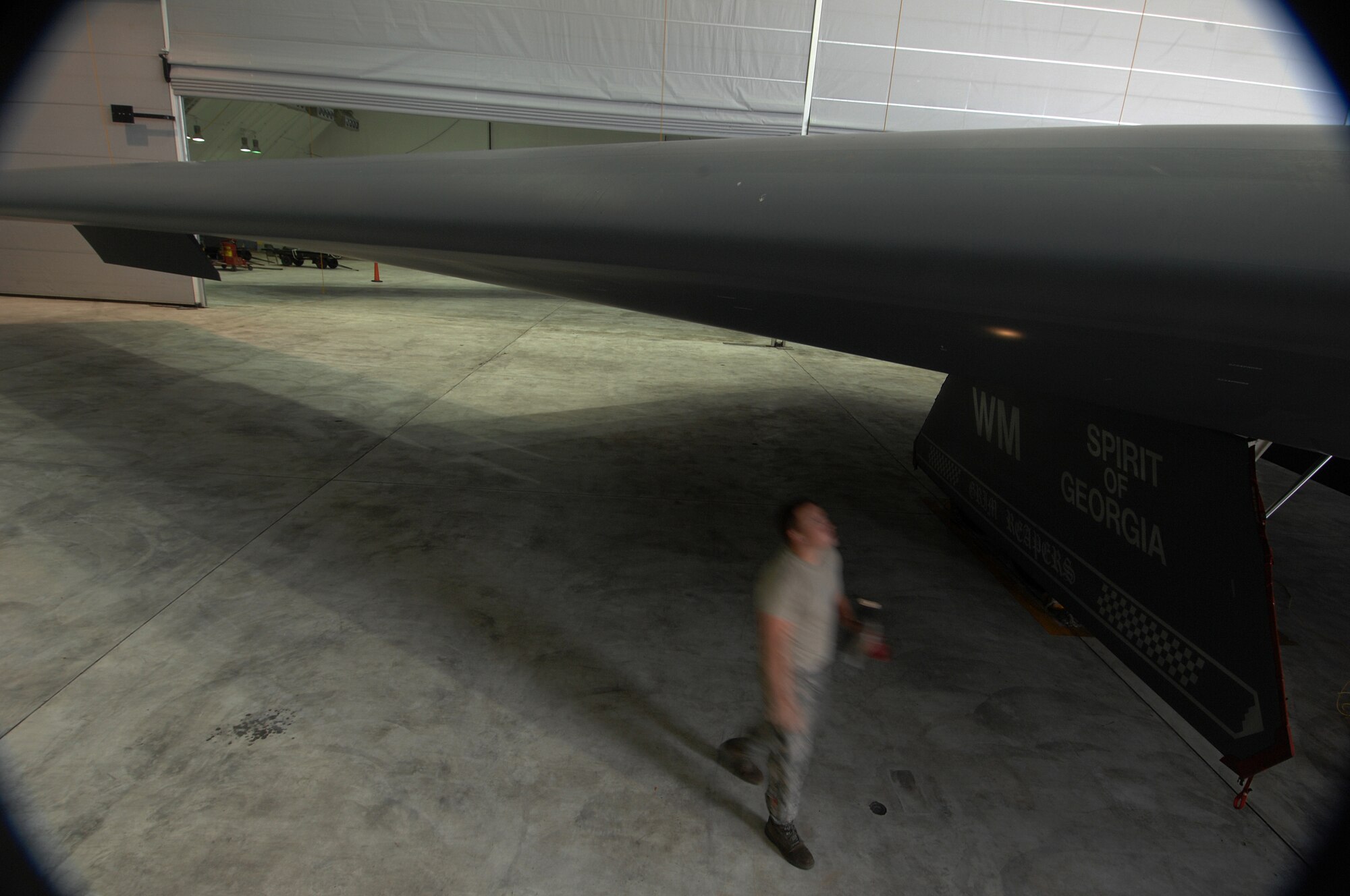 ANDERSEN AIR FORCE BASE, Guam -- Staff Sergeant Scott Kures walk around a wing to check for leaking drains as part of routine pre-flight maintenance on a B-2 Spirit stealth bomber. Sergeant Kures is part of a maintenance team supporting the remaining B-2 Spirits at Andersen AFB. Keeping the B-2 Spirit bomber at a mission-ready status requires lots of hard work and a huge team effort by all maintainers working on the multi-role stealth bomber. The B-2s here have remained suspended pending the results from a safety investigation board following the first-ever crash of a stealth bomber Feb. 23 here, at Andersen AFB. The continuous bomber presence demonstrates U.S. commitment to promote security and stability in the Pacific region. Sergeant Kures is with the 36th Expeditionary Aircraft Maintenance Squadron and is deployed from the 509th Bomb Wing, Whiteman, AFB, Mo. (U.S. Air Force photo by Staff Sgt. Vanessa Valentine)

