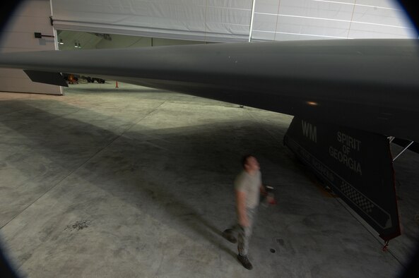ANDERSEN AIR FORCE BASE, Guam -- Staff Sergeant Scott Kures walk around a wing to check for leaking drains as part of routine pre-flight maintenance on a B-2 Spirit stealth bomber. Sergeant Kures is part of a maintenance team supporting the remaining B-2 Spirits at Andersen AFB. Keeping the B-2 Spirit bomber at a mission-ready status requires lots of hard work and a huge team effort by all maintainers working on the multi-role stealth bomber. The B-2s here have remained suspended pending the results from a safety investigation board following the first-ever crash of a stealth bomber Feb. 23 here, at Andersen AFB. The continuous bomber presence demonstrates U.S. commitment to promote security and stability in the Pacific region. Sergeant Kures is with the 36th Expeditionary Aircraft Maintenance Squadron and is deployed from the 509th Bomb Wing, Whiteman, AFB, Mo. (U.S. Air Force photo by Staff Sgt. Vanessa Valentine)

