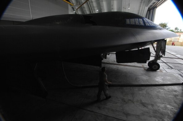 ANDERSEN AIR FORCE BASE, Guam -- Staff Sergeant Scott Kures walk around a wing to check for leaking drains as part of routine pre-flight maintenance on a B-2 Spirit stealth bomber. Sergeant Kures is part of a maintenance team supporting the remaining B-2 Spirits at Andersen AFB. Keeping the B-2 Spirit bomber at a mission-ready status requires lots of hard work and a huge team effort by all maintainers working on the multi-role stealth bomber. The B-2s here have remained suspended pending the results from a safety investigation board following the first-ever crash of a stealth bomber Feb. 23 here, at Andersen AFB. The continuous bomber presence demonstrates U.S. commitment to promote security and stability in the Pacific region. Sergeant Kures is with the 36th Expeditionary Aircraft Maintenance Squadron and is deployed from the 509th Bomb Wing, Whiteman, AFB, Mo. (U.S. Air Force photo by Staff Sgt. Vanessa Valentine)
