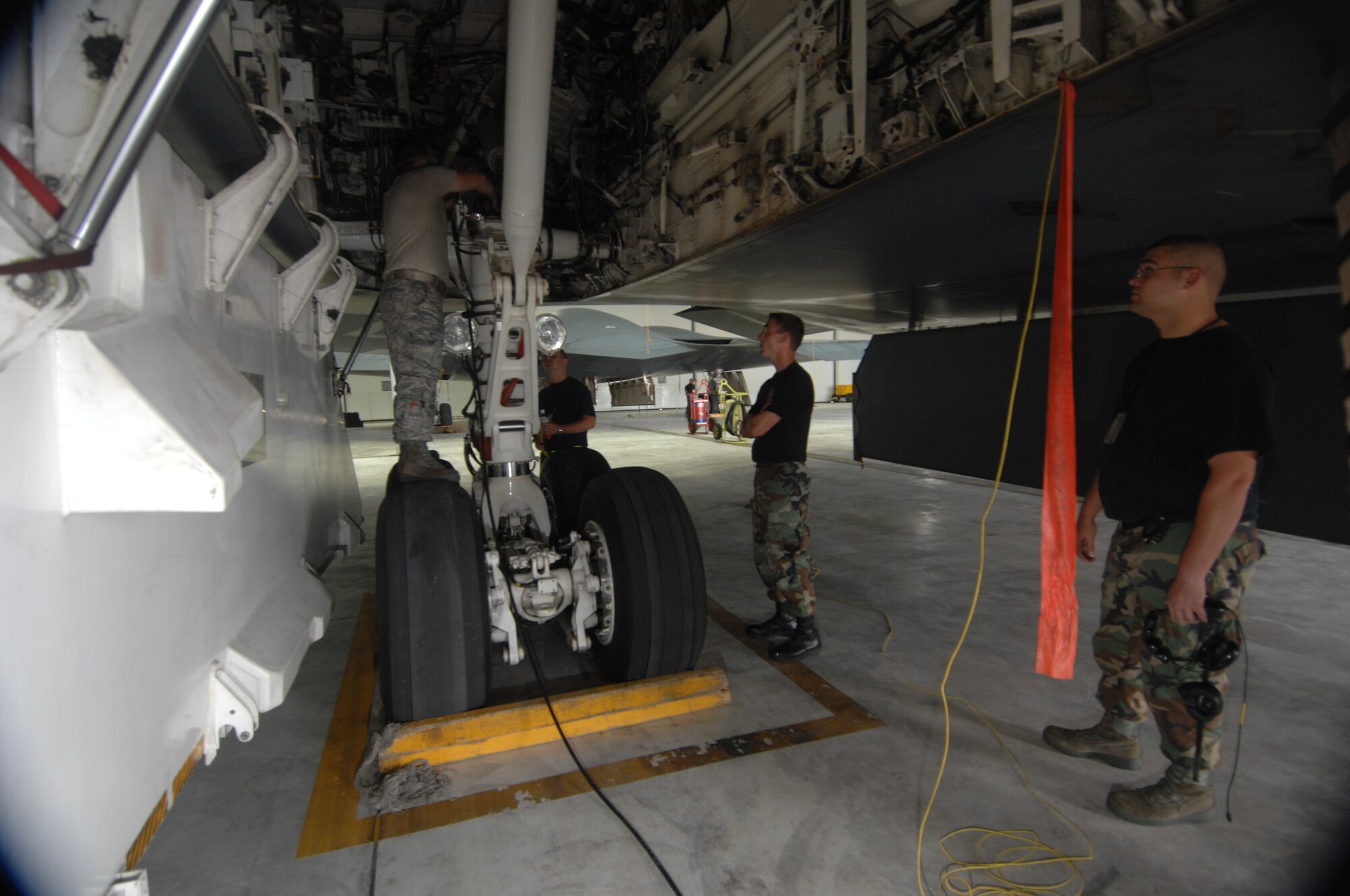 ANDERSEN AIR FORCE BASE, Guam - Airman from the 36th Expeditionary Aircraft Maintenance Squadron perform a routine pre-flight maintenance on a B-2 Spirit stealth bomber. The Airmen are part of a maintenance team supporting the remaining B-2 Spirits at Andersen AFB. Keeping the B-2 Spirit bomber at a mission-ready status requires lots of hard work and a huge team effort by all maintainers working on the multi-role stealth bomber. The B-2s here have remained suspended pending the results from a safety investigation board following the first-ever crash of a stealth bomber Feb. 23 here, at Andersen AFB. The continuous bomber presence demonstrates U.S. commitment to promote security and stability in the Pacific region. The B-2 Spirit Maintenance team is with the 36th EAMXS and is deployed from the 509th Bomb Wing, Whiteman, AFB, Mo. (U.S. Air Force photo by Staff Sgt. Vanessa Valentine)
