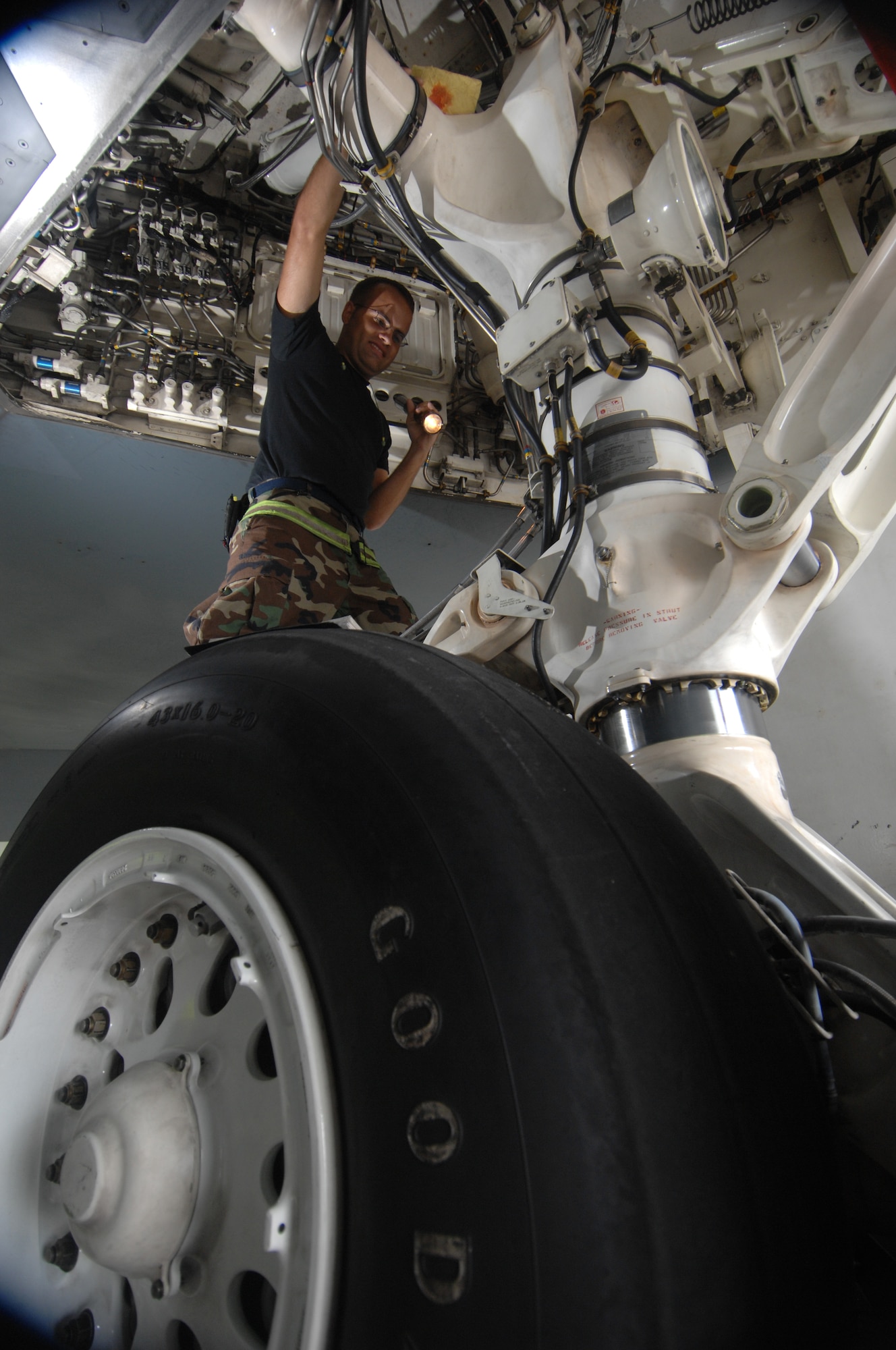 ANDERSEN AIR FORCE BASE, Guam -- Staff Sergeant Cory Cahill inspects a wheel well as part of routine pre-flight maintenance on a B-2 Spirit stealth bomber. Sergeant Cahill is part of a maintenance team supporting the remaining B-2 Spirits at Andersen AFB. Keeping the B-2 Spirit bomber at a mission-ready status requires lots of hard work and a huge team effort by all maintainers working on the multi-role stealth bomber. The B-2s here have remained suspended pending the results from a safety investigation board following the first-ever crash of a stealth bomber Feb. 23 here, at Andersen AFB. The continuous bomber presence demonstrates U.S. commitment to promote security and stability in the Pacific region. Sergeant Cahill is with the 36th Expeditionary Aircraft Maintenance Squadron and is deployed from the 509th Bomb Wing, Whiteman, AFB, Mo. (U.S. Air Force photo by Staff Sgt. Vanessa Valentine)

