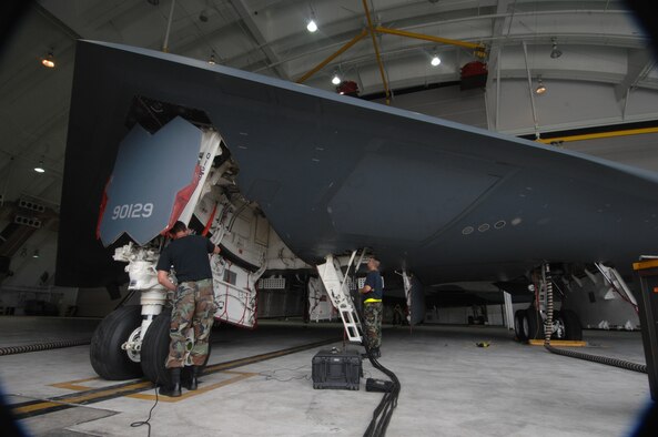 ANDERSEN AIR FORCE BASE, Guam -- Staff Sergeants Jamie Walker and Jonathan Sangricco perform routine pre-flight maintenance on a B-2 Spirit stealth bomber. Sergeants Walker and Sangricco are part of a maintenance team supporting the remaining B-2 Spirits at Andersen AFB. Keeping the B-2 Spirit bomber at a mission-ready status requires lots of hard work and a huge team effort by all maintainers working on the multi-role stealth bomber. The B-2s here have remained suspended pending the results from a safety investigation board following the first-ever crash of a stealth bomber Feb. 23 here, at Andersen AFB. The continuous bomber presence demonstrates U.S. commitment to promote security and stability in the Pacific region. Sergeants Walker and Sangricco are with the 36th Expeditionary Aircraft Maintenance Squadron and are deployed from the 509th Bomb Wing, Whiteman, AFB, Mo. (U.S. Air Force photo by Staff Sgt. Vanessa Valentine)