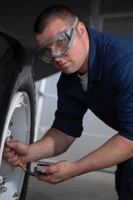 ANDERSEN AIR FORCE BASE, Guam - Senior Airman Walter Costen checks a tire’s air pressure as part of routine pre-flight maintenance. Airman Costen is part of a maintenance team supporting the remaining B-2 Spirits at Andersen AFB. Keeping the B-2 Spirit bomber at a mission-ready status requires lots of hard work and a huge team effort by all maintainers working on the multi-role stealth bomber. The B-2s here have remained suspended pending the results from a safety investigation board following the first-ever crash of a stealth bomber Feb. 23 here, at Andersen AFB. The continuous bomber presence demonstrates U.S. commitment to promote security and stability in the Pacific region. Airman Costen is with the 36th Expeditionary Aircraft Maintenance Squadron and is deployed from the 509th Bomb Wing, Whiteman, AFB, Mo. (U.S. Air Force photo by Staff Sgt. Vanessa Valentine) 
