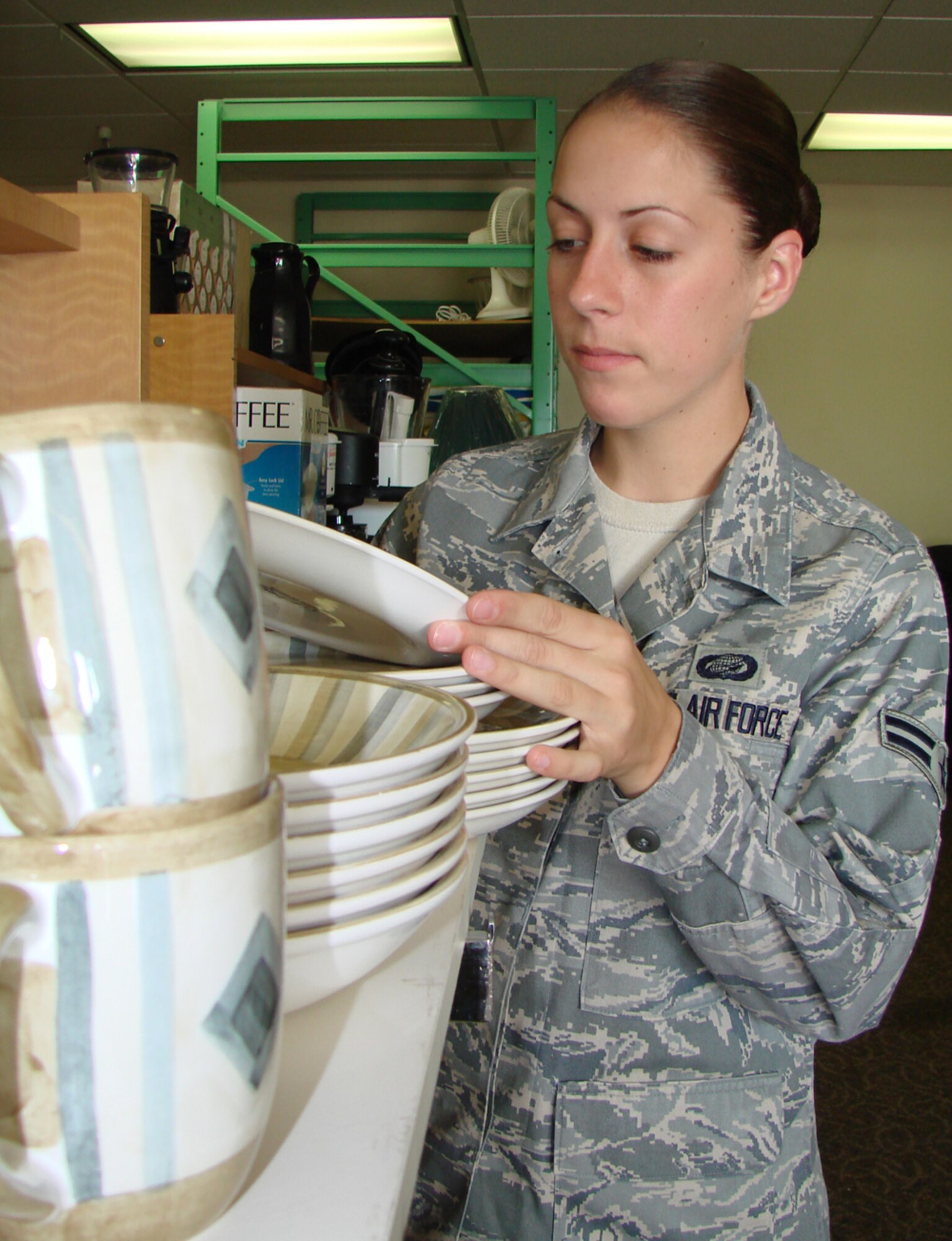 Airman 1st Class Jennifer Byrge, 71st Force Support Squadron, shops at the Airman's Attic near the Base Exchange in Bldg. 415.  The Airman's Attic, which is run by the Enlisted Spouses Group, is open 11 a.m. to 1 p.m., Wednesdays, and on the first Saturday of every month from 10 a.m. to noon. The shop provides free household items for E-1s to E-4s. For more information or to donate items, contact group first sergeants. (U.S. Air Force photo by Tech. Sgt. Mary Davis)      