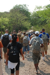 Joint Task Force-Bravo personnel head out to deliver two and one half tons of staple foods to two villages near Humuya, Honduras, April 26. The three-mile hike was part of JTF-Bravo's ongoing chapel hike program. (U.S. Air Force photo by 1st Lt. Erika Yepsen)