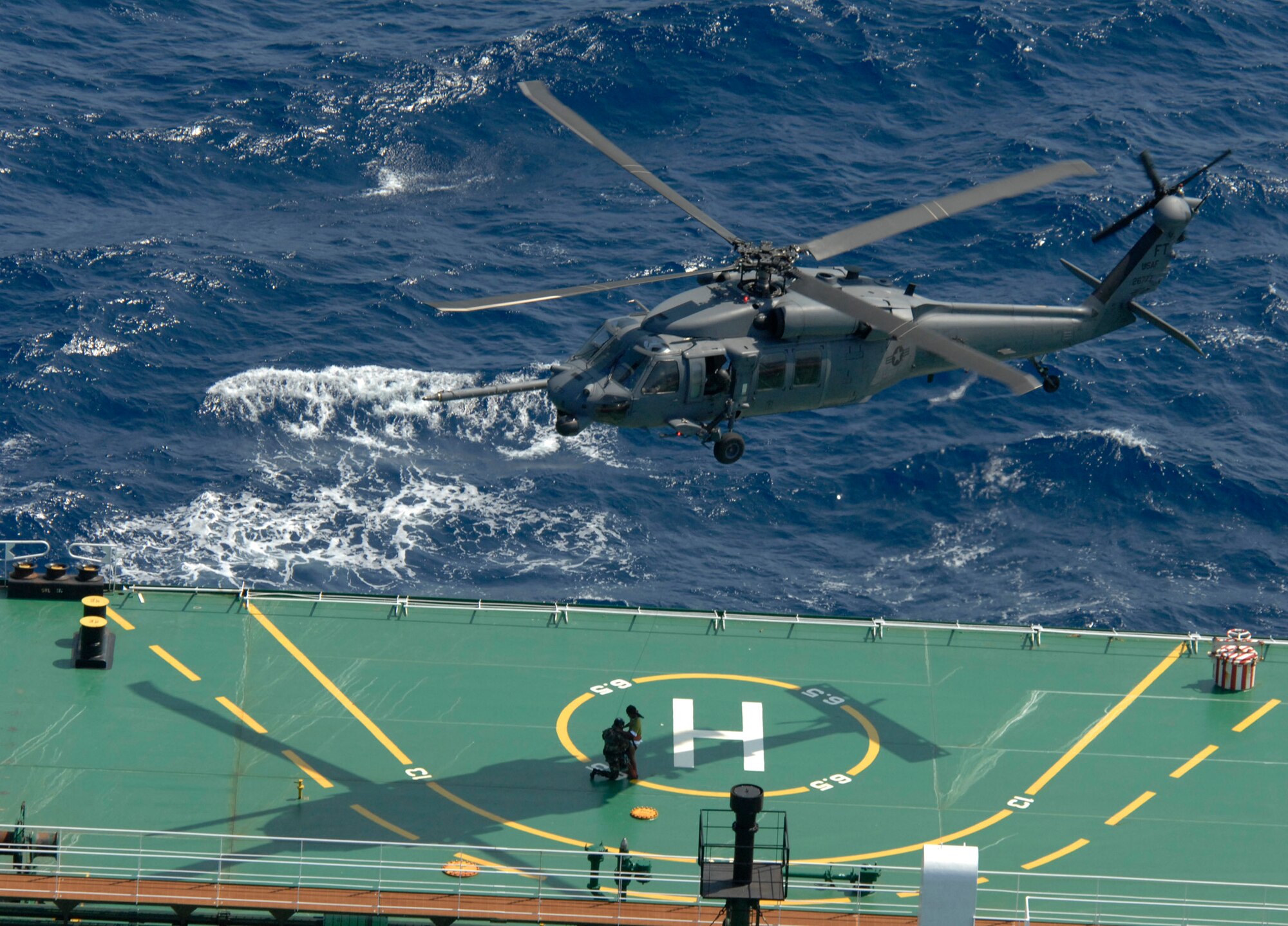 An HH-60G Pave Hawk from the 41st Rescue Squadron out of Moody Air Force Base, Ga., picks up a 38th Rescue Squadron pararescueman and a survivor off a ship approximately 260 miles south of New Orleans, La., during a rescue mission April 25. Responding to a request for support from the U.S. Coast Guard, two HH-60G Pave Hawk helicopters and a 71st Rescue Squadron HC-130P King performed a 10-hour mission to retrieve Cuban migrants in distress that had been picked up by a passing ship. Subsequently, five adults and one child were hoisted from the tanker and transported to a medical facility in New Orleans. (U.S. Air Force photo/Senior Airman Gina Chiaverotti) 