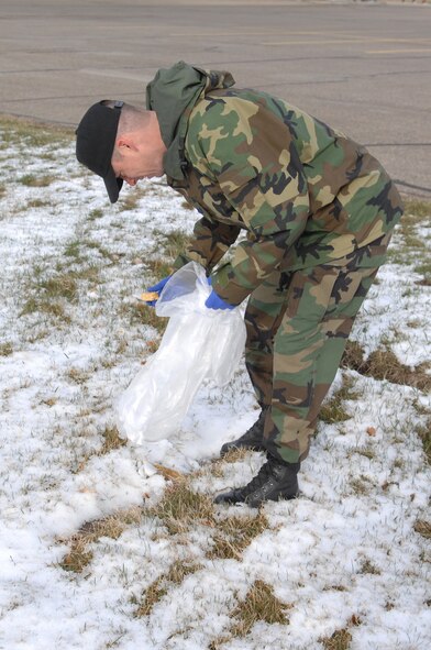 MINOT AIR FORCE BASE, N.D.—Tech. Sgt James Hayes, the NCO in charge of Chapel Services from the 5th Bomb Wing, does his part to help clean the base April 25. Each squadron on base participated in the annual base-wide clean-up. (U.S. Air Force photo by Senior Airman Cassandra Jones)