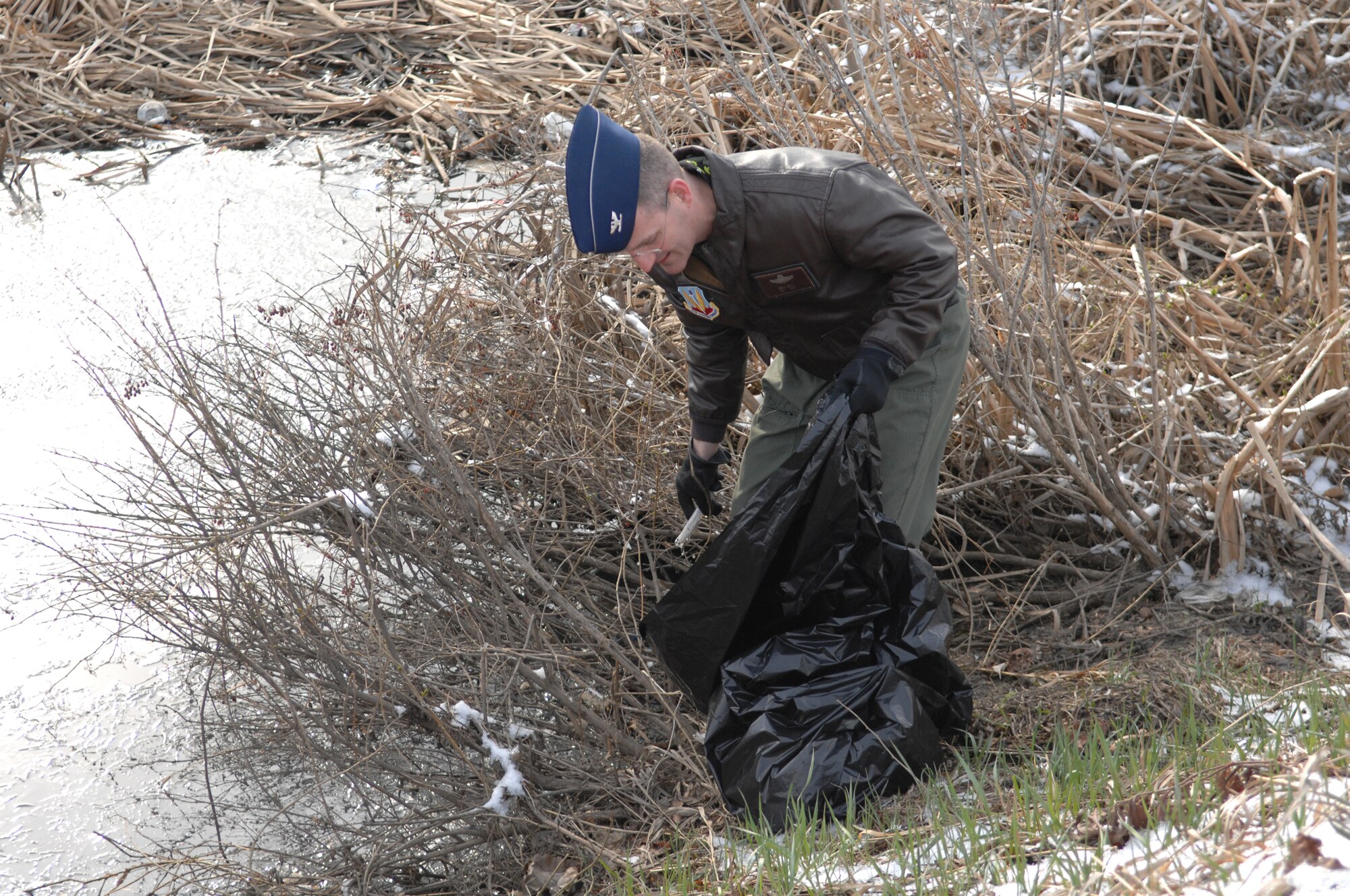 MINOT AIR FORCE BASE, N.D. - Col. Greg Bell, 5th Bomb Wing vice commander,
does his part to help clean the base April 25 during a base-wide
clean-up here. Every squadron on base participated in the annual event.  (U.S. Air Force photo by
Senior Airman Cassandra Jones)
