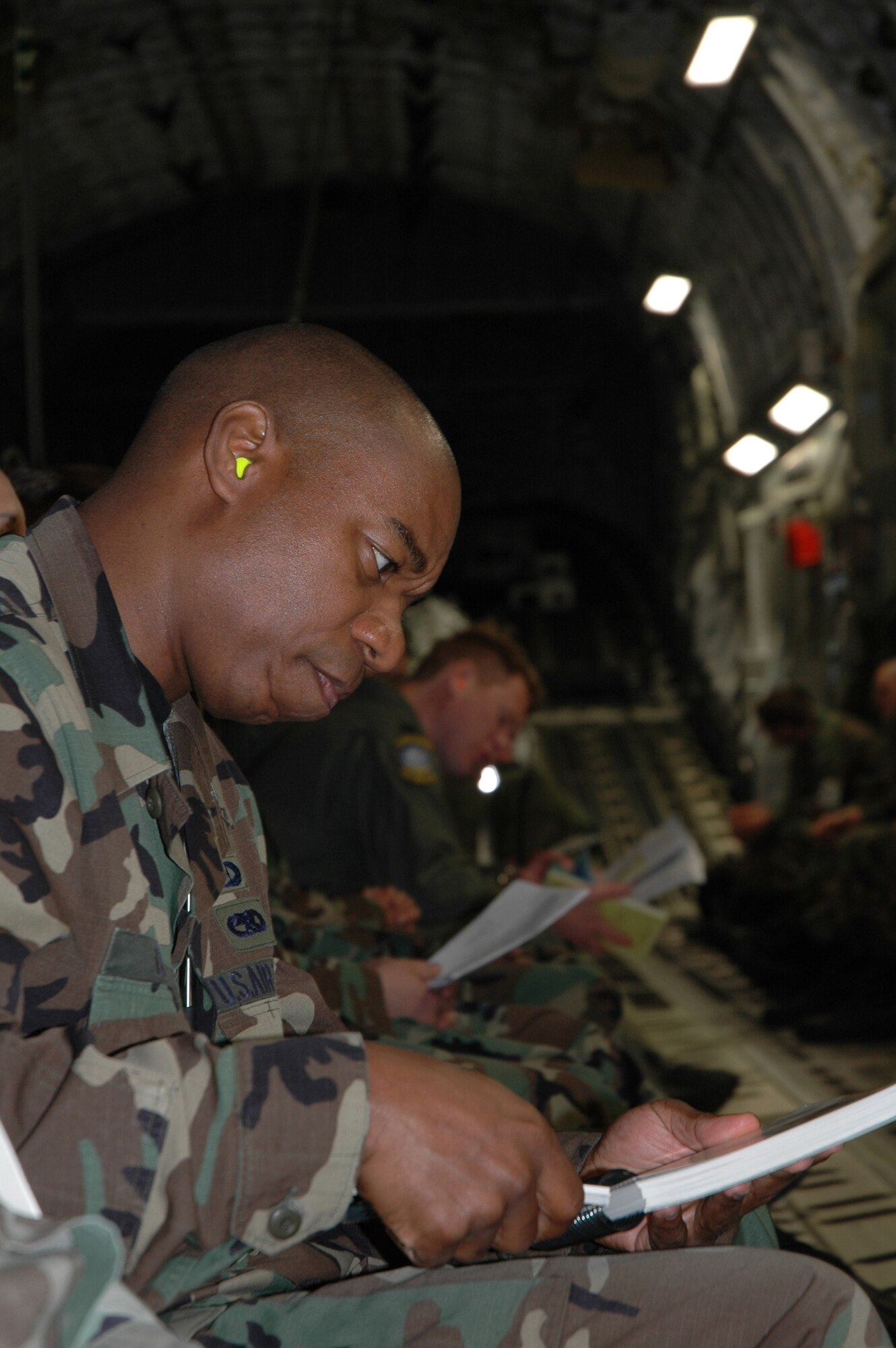 Staff Sgt. Donavan Brown, 512th Airlift Wing chaplain asssitant, makes good use of his flight time to Alpena, Mich., April 21 by brushing up on ability to survive and operate skills outlined in in the Airman's Manual. Sergeant Brown participated in the Operational Readiness Exercise, which was a dry run for the Operational Readiness Inspection in July.  