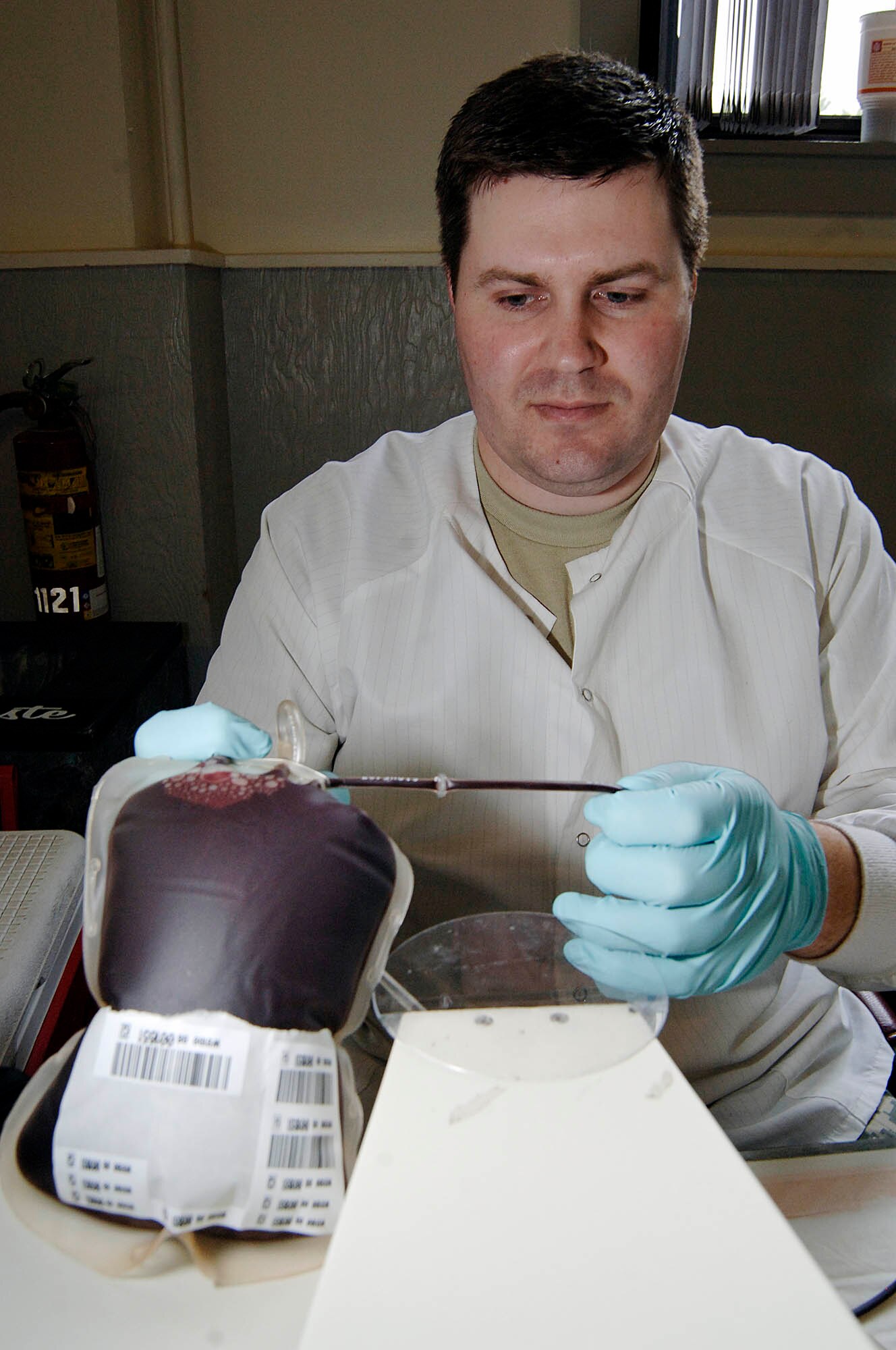 FAIRCHILD AIR FORCE BASE, Wash. – Spc. Ryan Squires, Armed Services Blood Bank Center medical technician, processes a blood unit on April 24 at the Deel community center. The ASBC is located in the Madigan Army Medical Center at Fort Lewis, Wash. It is one of the largest hospitals on the west coast and aids in getting needed blood to deployed troops in theater. (U.S. Air Force photo / Staff Sergeant JT May III)