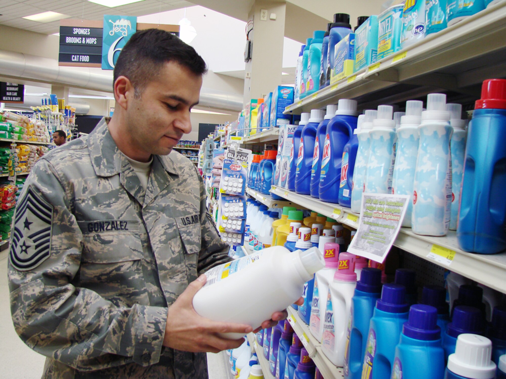 Chief Master Sgt. Ruben Gonzalez, 71st Flying Training Wing command chief, reads a label of a detergent approved for laundering Airman Battle Uniforms. The Vance Commissary posted signs recently to indicate detergents approved for ABUs laundering. For a complete list of approved detergents, visit the Air Force Portal Web site. (U.S. Air Force photo by Tech. Sgt. Mary Davis)