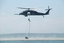 Rescue Reservists from the 920th Rescue Wing at Patrick Air Force Base, Fla. train for water rescue recovery on the Banana River which borders the base to the west. They consistently train on the portion of the river called the Judy Drop Zone. The pararescueman seen here is fast-roping from an HH-60G Pave Hawk helicopter piloted by aircrew from the wing?s 301st Rescue Squadron. The rescue crews use this technique to board ships at sea. (U.S. Air Force Photo/Jasmine DeNamur)