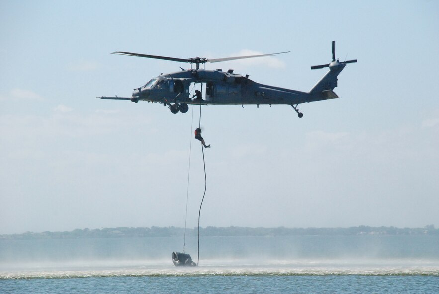 Rescue Reservists from the 920th Rescue Wing at Patrick Air Force Base, Fla. train for water rescue recovery on the Banana River which borders the base to the west. They consistently train on the portion of the river called the Judy Drop Zone. The pararescueman seen here is fast-roping from an HH-60G Pave Hawk helicopter piloted by aircrew from the wing?s 301st Rescue Squadron. The rescue crews use this technique to board ships at sea. (U.S. Air Force Photo/Jasmine DeNamur)
