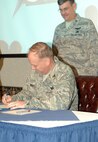 MINOT AIR FORCE BASE, N.D. -- Col. Joel Westa, the 5th Bomb Wing commander, signs for STARBASE April 25 at Jimmy Doolittle Center here. (U.S. Air Force photo by Airman 1st Class Benjamin Stratton)