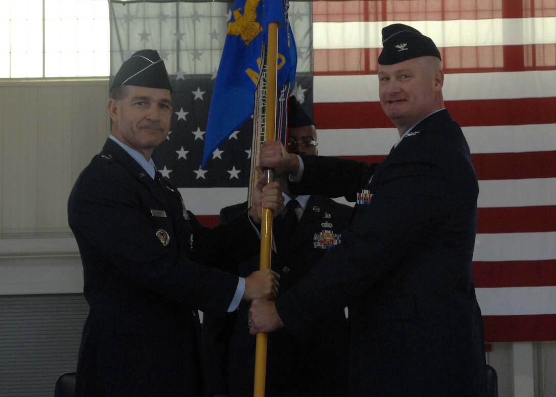 LANGLEY AIR FORCE BASE, Va. -- Brig. Gen. Mark Barrett, 1st Fighter Wing commander, presents the guidon to Col. Kevin Altman, the new 1st Mission Support Group commander, during the 1st MSG change of command ceremony here April 24.  (U.S. Air Force photo/Senior Airman Cecil McCloud)