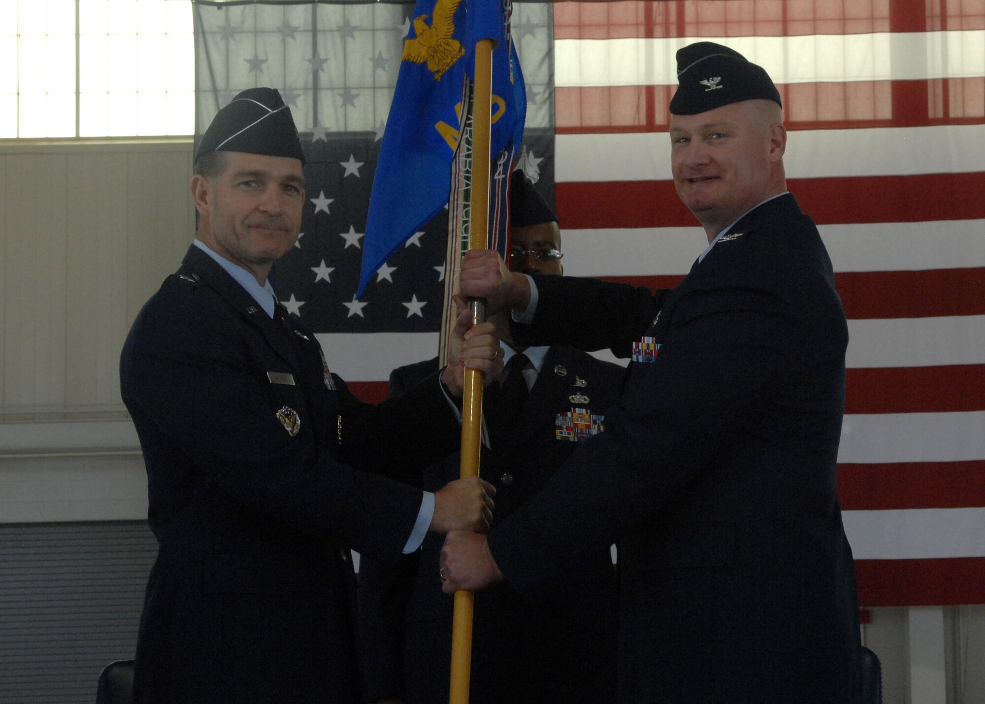 LANGLEY AIR FORCE BASE, Va. -- Brig. Gen. Mark Barrett, 1st Fighter Wing commander, presents the guidon to Col. Kevin Altman, the new 1st Mission Support Group commander, during the 1st MSG change of command ceremony here April 24.  (U.S. Air Force photo/Senior Airman Cecil McCloud)