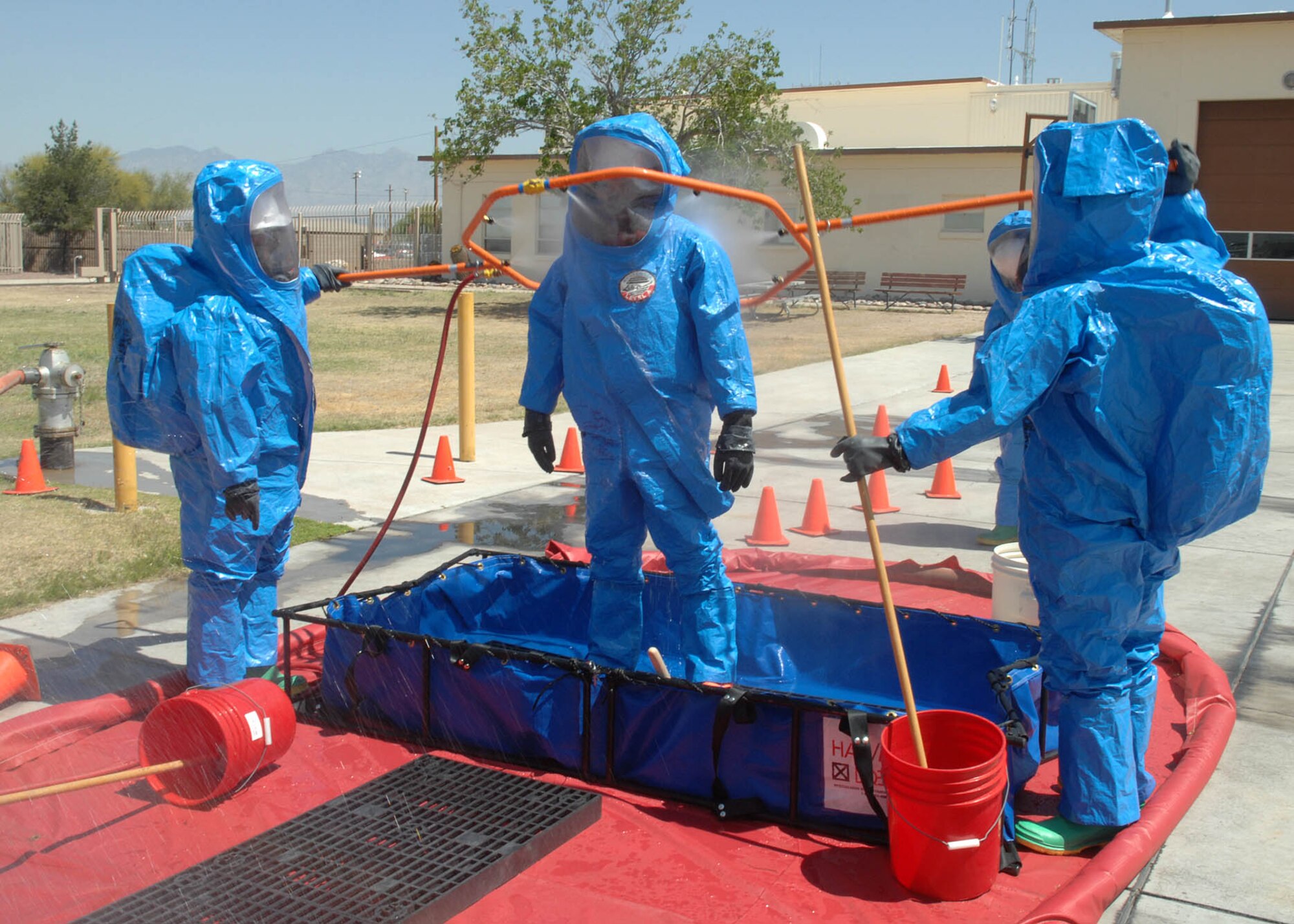 Airmen and Guardsman from the 355th Civil Engineer Squadron and the Arizona Air National Guard firefighters, come together to decontaminate the personnel that has been in the “hot zone” to fix the leak during a Hazardous Material Technician course at Davis-Monthan Air Force Base, Arizona on April 23, 2008. The Guardsmen were here to learn with Airmen from D-M what are the procedures are if an accident should happen.  With the combined efforts of both sides were able to train 18 personnel.  All firefighters in the Air Force need to complete this training for one of the requirements for upgrade.  The Guardsmen are from the Arizona Air National Guard in Tucson, Arizona.