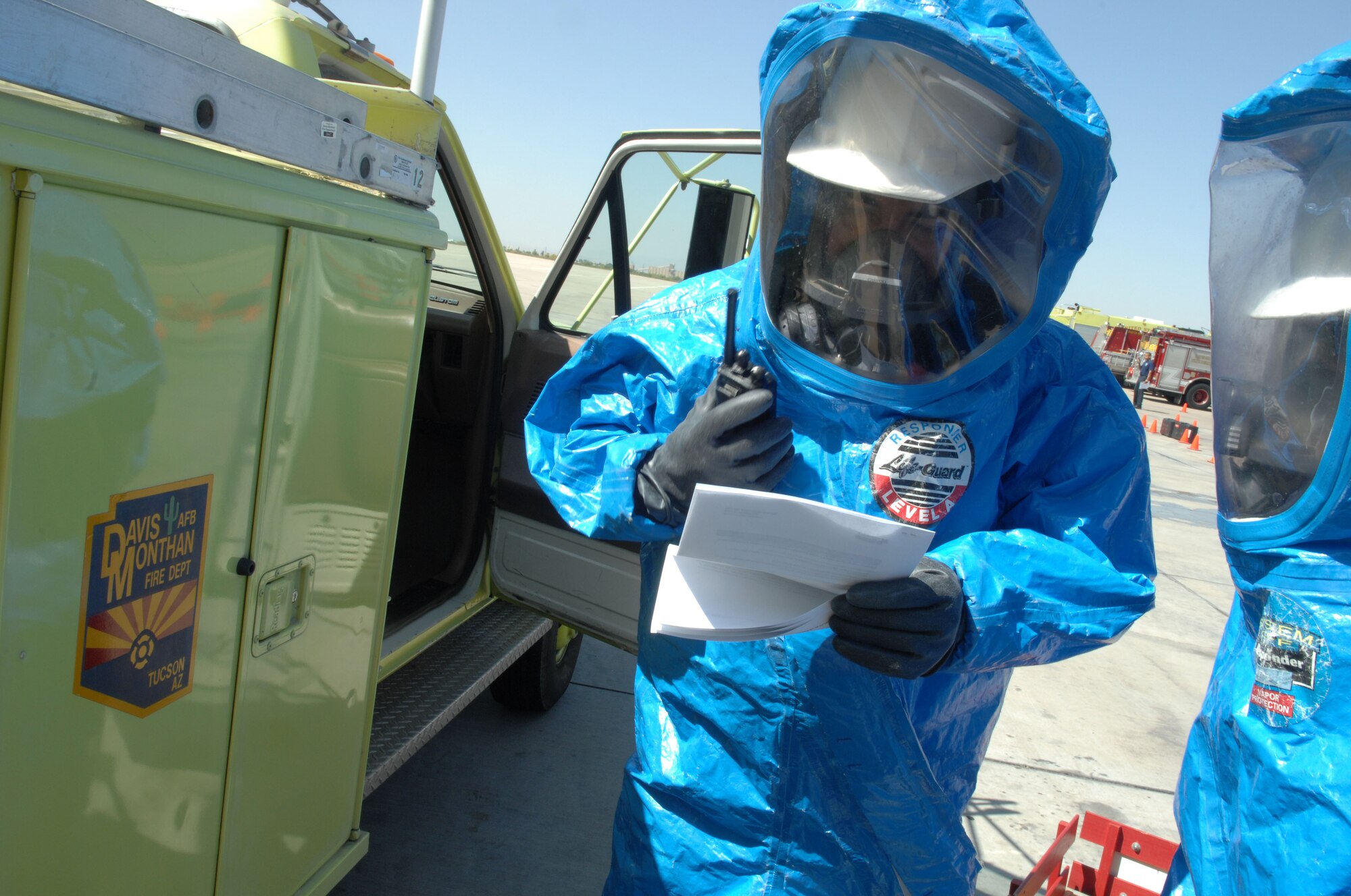 Staff Sergeant Andres Carroll and Staff Sergeant Rodmar Manarang, 162nd Guardsmen firefighters, call the substance back to dispatch during a Hazardous Material Technician course at Davis-Monthan Air Force Base, Arizona on April 23, 2008.  The Guardsmen were here to learn with airmen from D-M what are the procedures if something where to happen with hazmat materials.  With the training combining with the Guardsmen and Airmen they were able to train 18 students.  All firefigthers in the Air Force need this course to meet upgrade training. The Guardsmen are stationed at the Arizona Air National Guard base here in Tucson, Arizona.  (US Photo By: SrA Jacqueline Hawkins)
