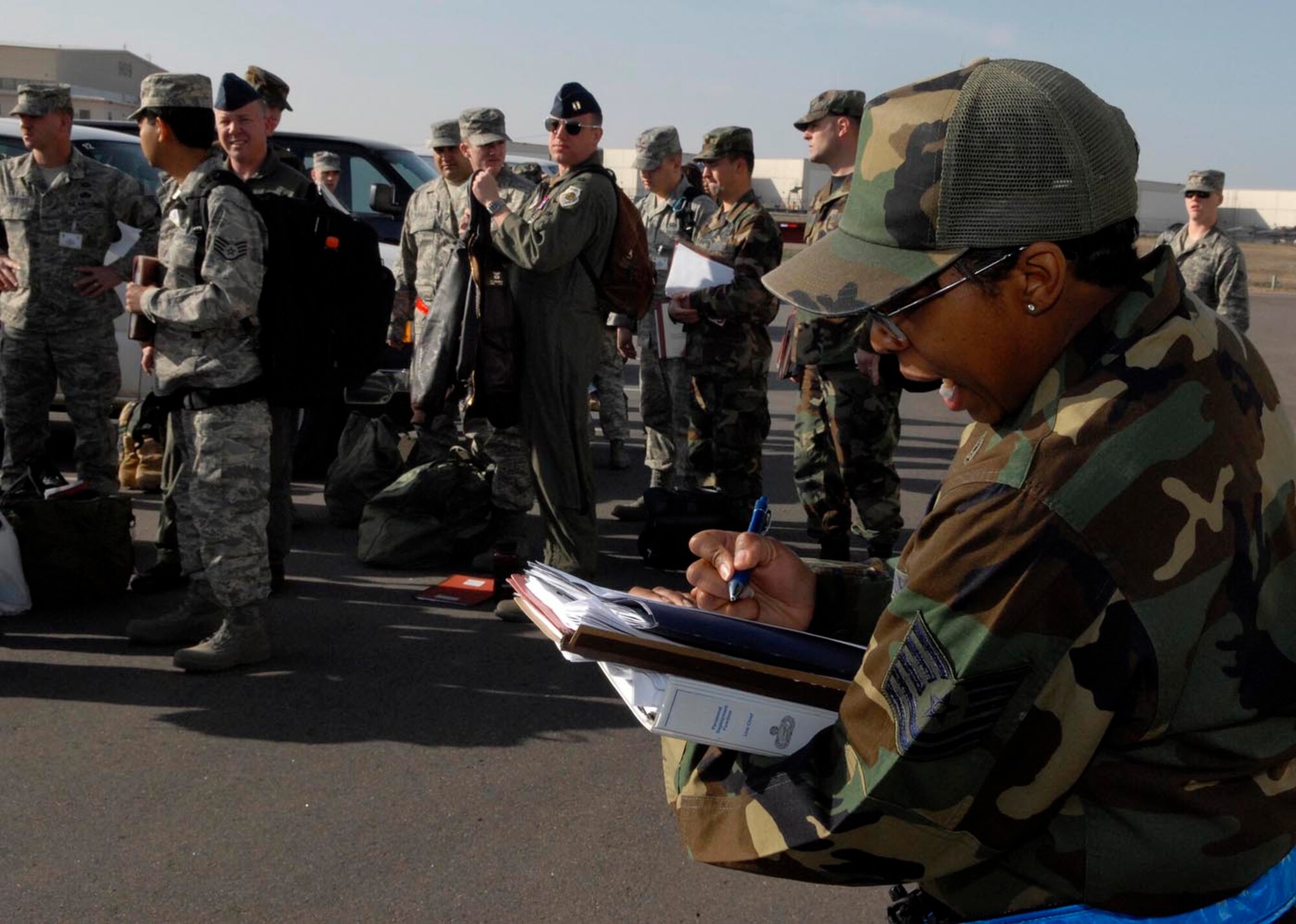 BUCKLEY AIR FORCE BASE, Colo. -- Tech. Sgt. Aleisha Jordan, 460th Mission Support Squadron, calls out the names of everyone who was evacuated from the deployment line when an "exercise" suspicious package was found during the Operational Readiness Inspection here April 23. (U.S. Air Force photo by Senior Airman Steve Czyz)