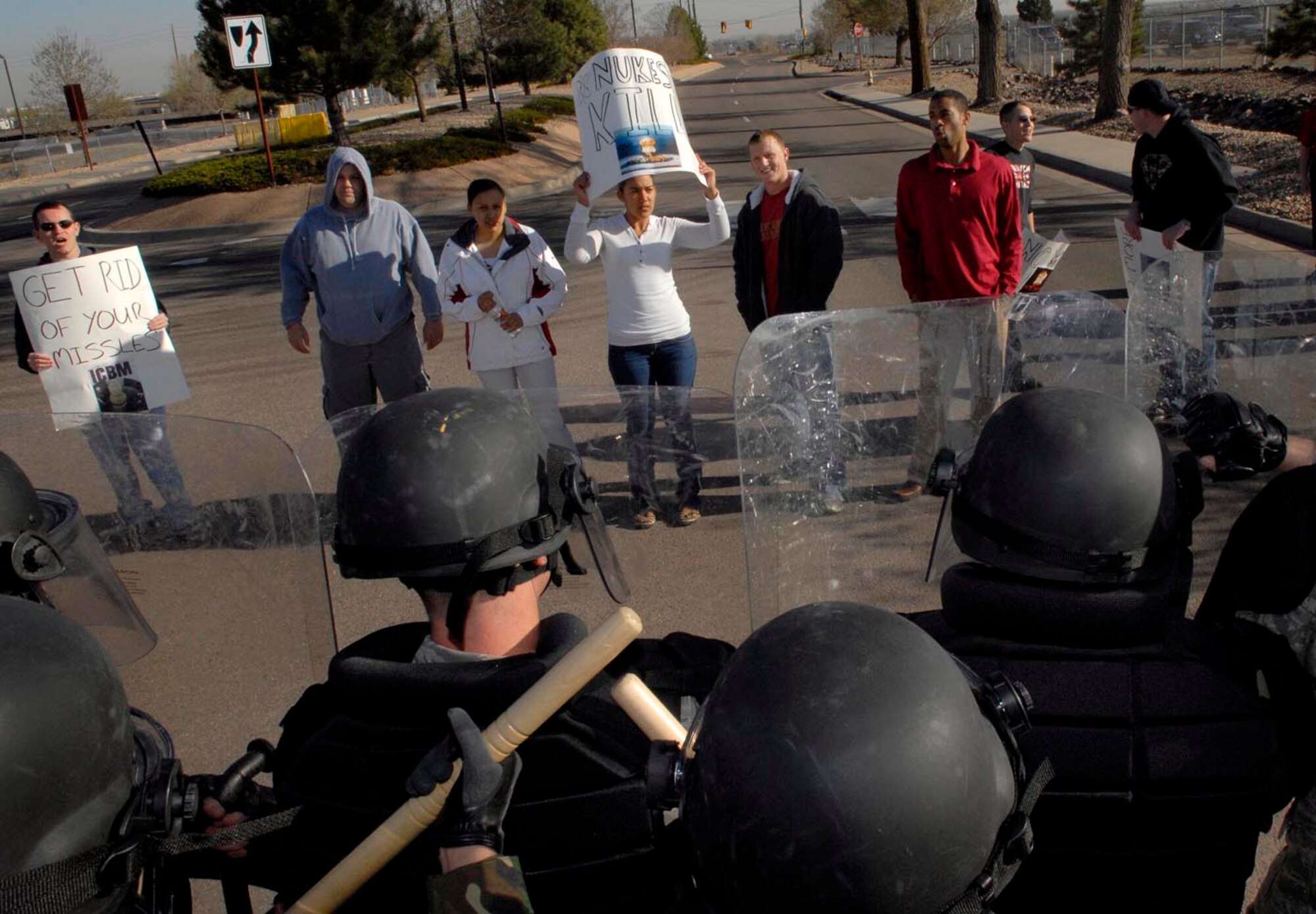 BUCKLEY AIR FORCE BASE, Colo. -- Airmen pose as protesters while the confrontaion management team guards the base during the base's Operational Readiness Inspection here April 23.(U.S. Air Force photo by Senior Airman Steve Czyz)