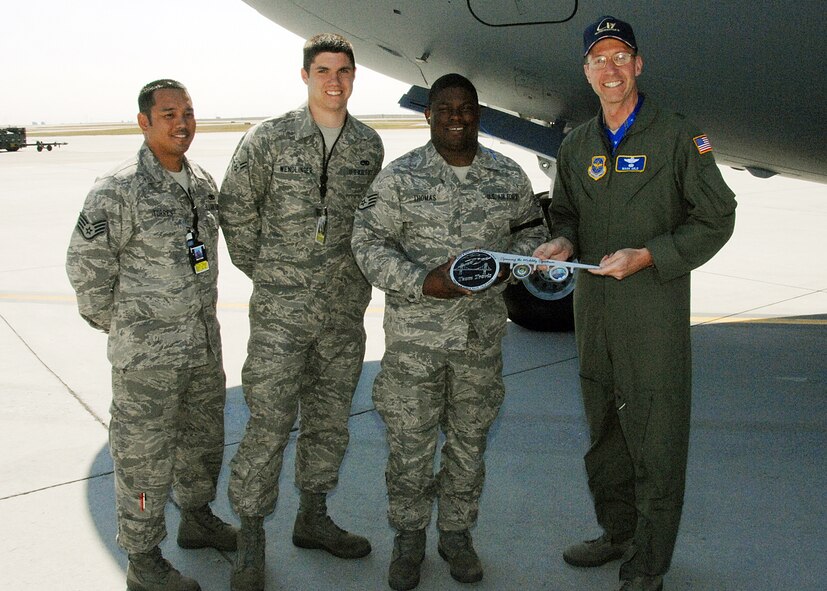 Brig Gen Mark S. Solo, Deputy Director, Air, Space and Information Operations, Headquarters Air Mobility Command presents the "Keys" to C-17 Tail Number 77172 to Travis Maintenance personel. From right to left, SSgt Bernard M. Thomas, 860 AMXS, A1C Michael  Wendlinger 860 AMXS and SSgt Mathew C. Torres, 860 AMXS. Brig Gen Solo was the delivery official for this C-17, which is the twelfth of  thirteen C-17s scheduled to be delivered to Travis AFB.U.S. Air Force Photo by David W. Cushman, DAFC
