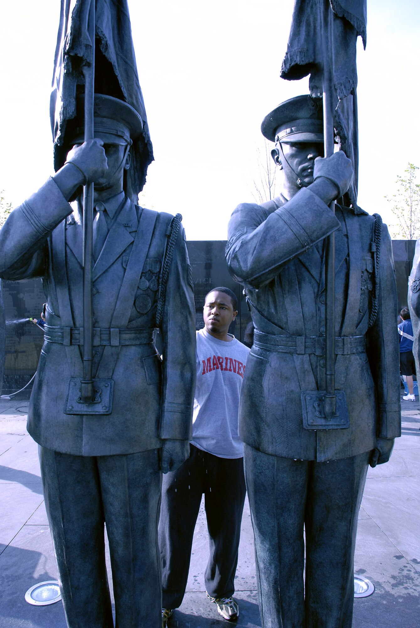 U.S. Marine Corps Reserve Cpl. Chris Still cleans a bronze honor guard statue during a work party April 19 at the Air Force Memorial.  Corporal Still was invited by Tech. Sgt. Terisa Pennington to join her and more than 50 volunteers from Air Force Sergeants Association Chapter 300 in Washington D.C. to help spruce up the site. Dedicated on Oct., 14, 2006, the memorial honors the service and sacrifice of the men and women of the United States Air Force and its predecessor organizations.  The wall bears the inscriptions of combat campaigns and expeditionary operations and contains the words of Air Force leaders that relate to the service's core values of Integrity First, Service Before Self and Excellence in All We Do. The memorial is located just outside the nation's capital in Arlington, Va., adjacent to Arlington National Cemetery and overlooking the Pentagon.  (U.S. Air Force photo/Senior Master Sgt. Matt Proietti)