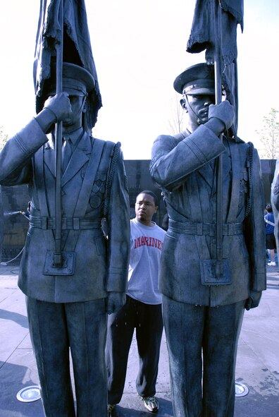 U.S. Marine Corps Reserve Cpl. Chris Still cleans a bronze honor guard statue during a work party April 19 at the Air Force Memorial.  Corporal Still was invited by Tech. Sgt. Terisa Pennington to join her and more than 50 volunteers from Air Force Sergeants Association Chapter 300 in Washington D.C. to help spruce up the site. Dedicated on Oct., 14, 2006, the memorial honors the service and sacrifice of the men and women of the United States Air Force and its predecessor organizations.  The wall bears the inscriptions of combat campaigns and expeditionary operations and contains the words of Air Force leaders that relate to the service's core values of Integrity First, Service Before Self and Excellence in All We Do. The memorial is located just outside the nation's capital in Arlington, Va., adjacent to Arlington National Cemetery and overlooking the Pentagon.  (U.S. Air Force photo/Senior Master Sgt. Matt Proietti)