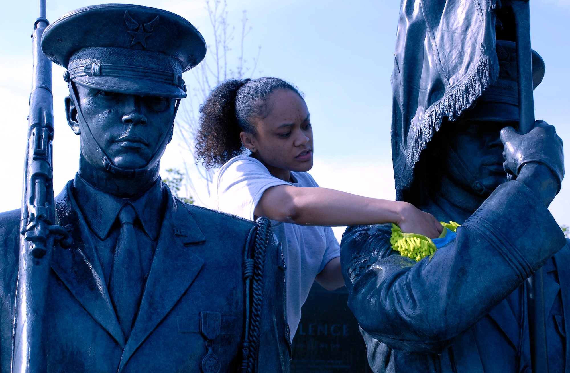 Tech. Sgt. Terisa Pennington scrubs a bronze honor guard statue during a work party April 19 at the Air Force Memorial.  More than 50 volunteers from Air Force Sergeants Association Chapter 300 in Washington D.C. gathered to help spruce up the site.  Dedicated on Oct., 14, 2006, the memorial honors the service and sacrifice of the men and women of the United States Air Force and its predecessor organizations.  The wall bears the inscriptions of combat campaigns and expeditionary operations and contains the words of Air Force leaders that relate to the service's core values of Integrity First, Service Before Self and Excellence in All We Do. The memorial is located just outside the nation's capital in Arlington, Va., adjacent to Arlington National Cemetery and overlooking the Pentagon.  (U.S. Air Force photo/Senior Master Sgt. Matt Proietti)