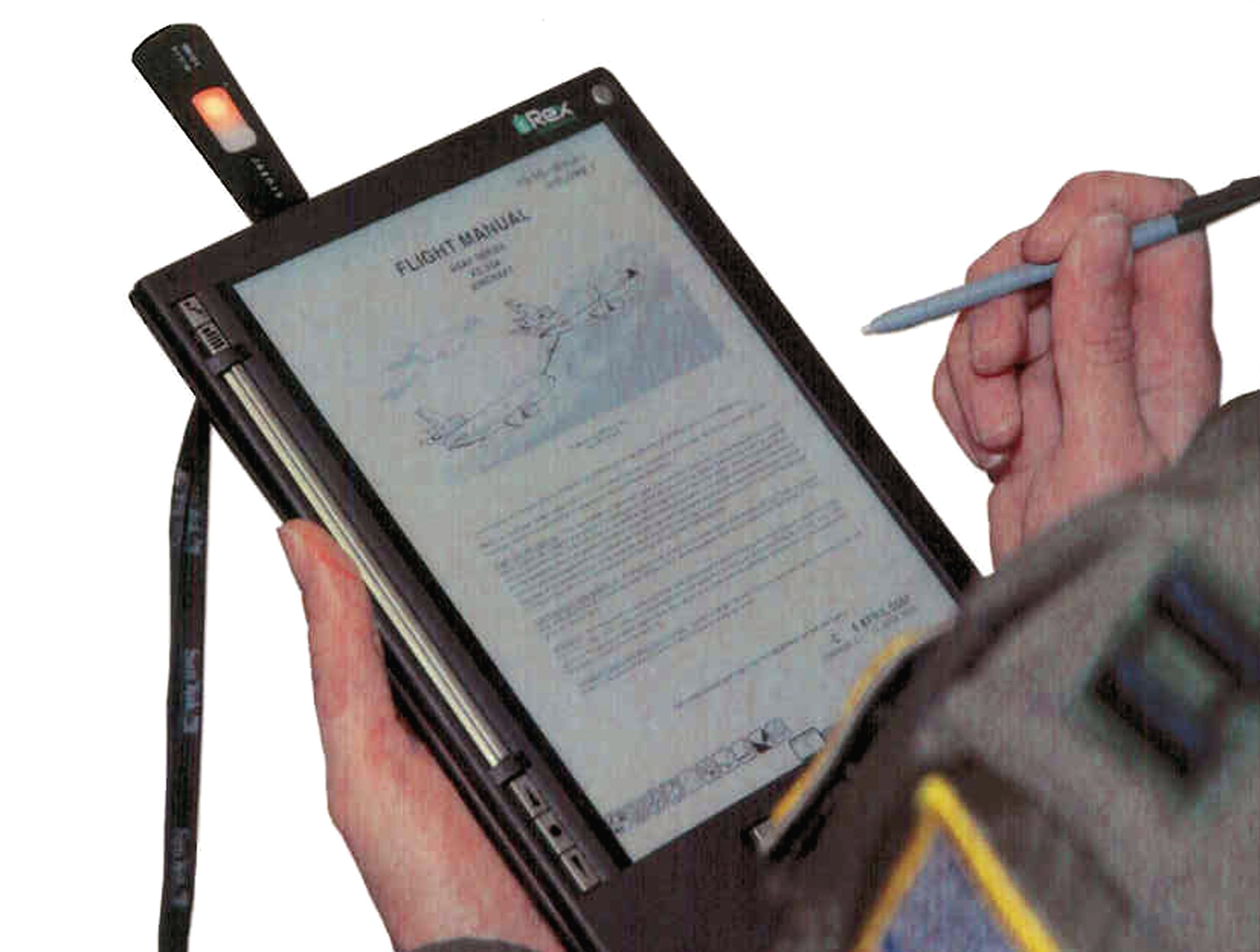 The iRex Iliad e-Reader, a "commercial-off-the-shelf" portable publications reader able to store data and read data from USB-compatible flash drives was the device used by the U.S. Air Force Expeditionary Center's Air Mobility Battlelab at Fort Dix, N.J., for their demonstration of the Paperless Aircrew Publications e-Reader initiative.  Through the AMB's work, the reader or one like it is being recommended to help aircrews carry less paper for their flying missions.  (Air Force photo illustration/Art Tollefson) 