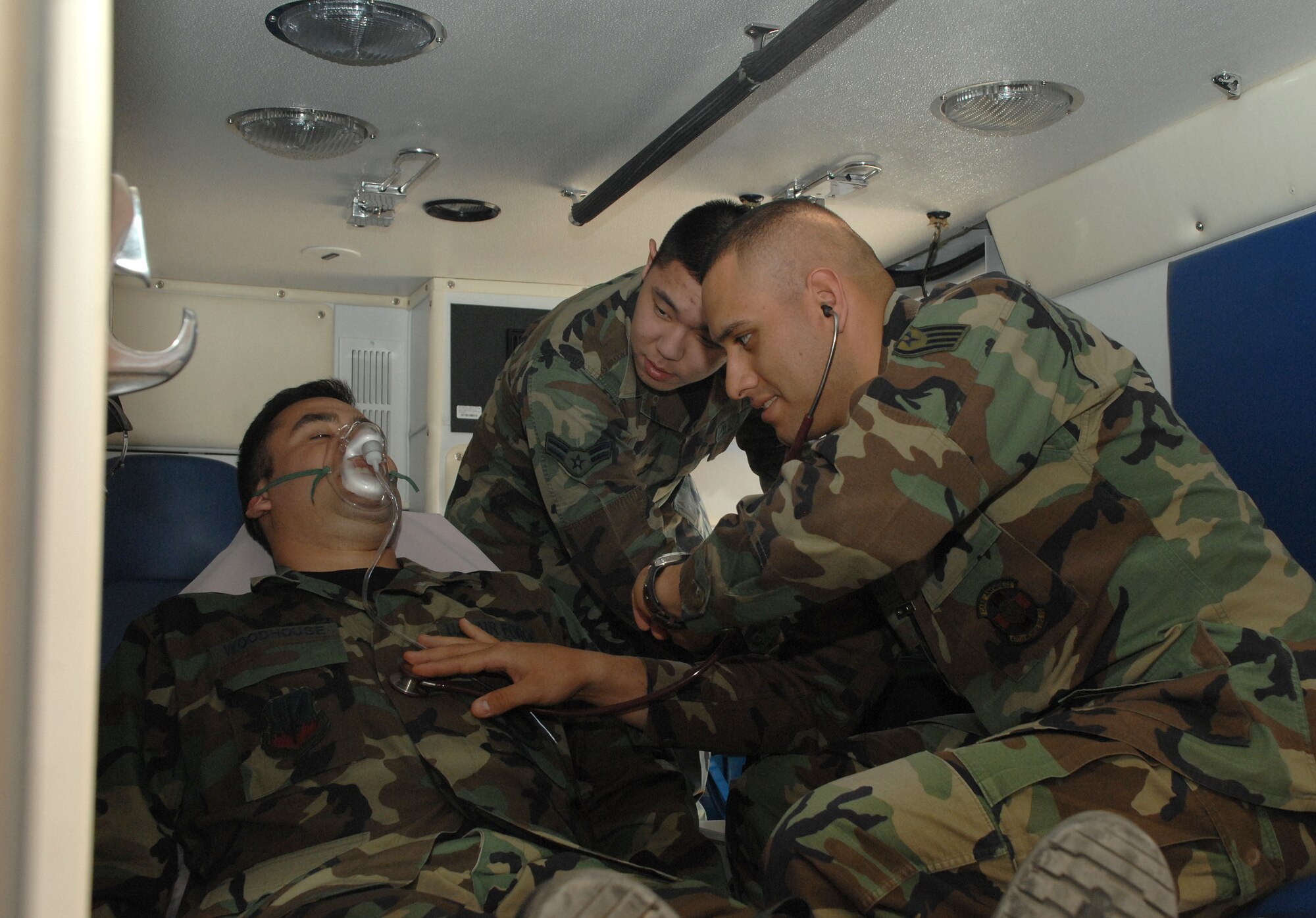 Staff Sgt. Michael Woodhouse, Stqrr Sgt. Adrian Estrada and Airman 1st Class Boshen Yu, all from the 49th Medical Group, simulate an emergeny resuscitation.They are among the many technicians being recognized during National Nurse's Week. (USAF photo by Airman 1st Class Tiffany Trojca)