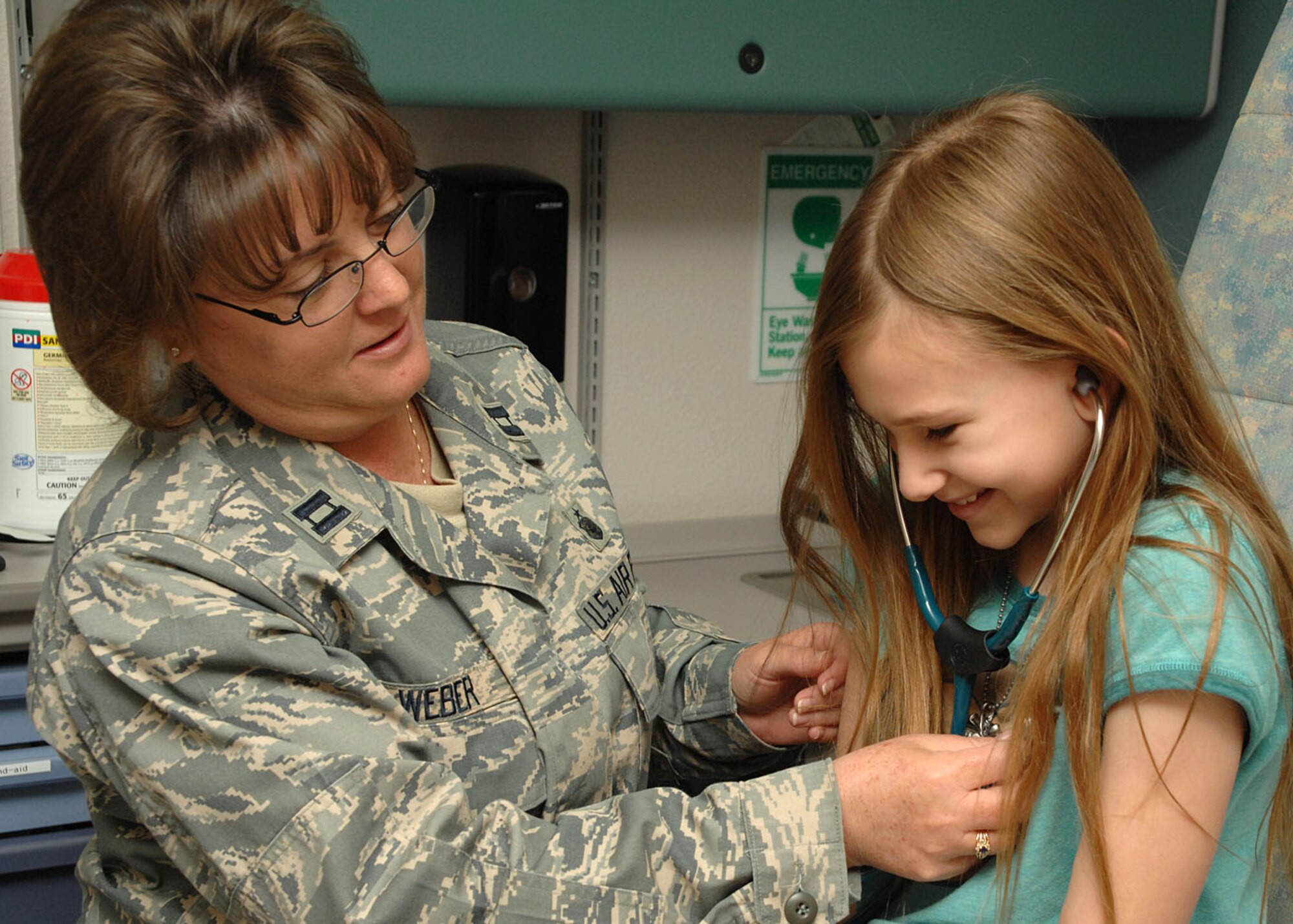 Pediatric Element Chief Captain Theresa Weber lets Holly Berghold use a stethoscope to listen to her heart beat. Captain Weber is a nurse her at the 49th Medical Group. (USAF photo by Airman 1st Class Tiffany Trojca)