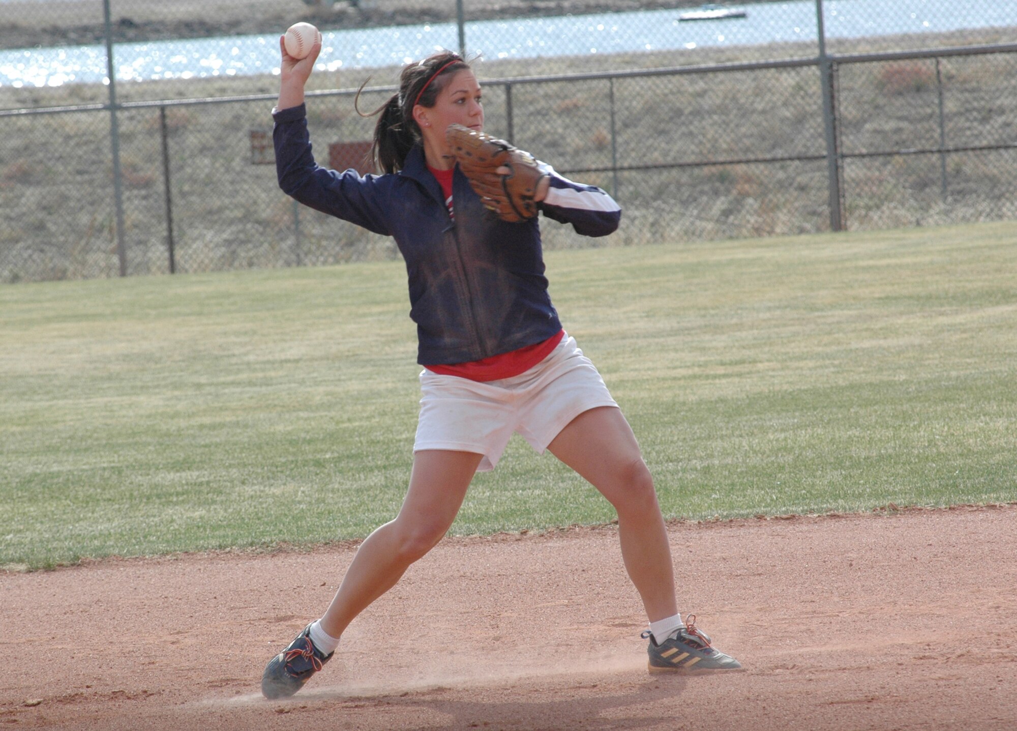 Crystal Darling, the youngest player at the April 17 tryouts, fields ground balls during infield practice drills at the Peterson Softball complex. The base team tryouts, conducted by Coach Angela Young, continued through April 26. (CSMNG photo/Walt Johnson)