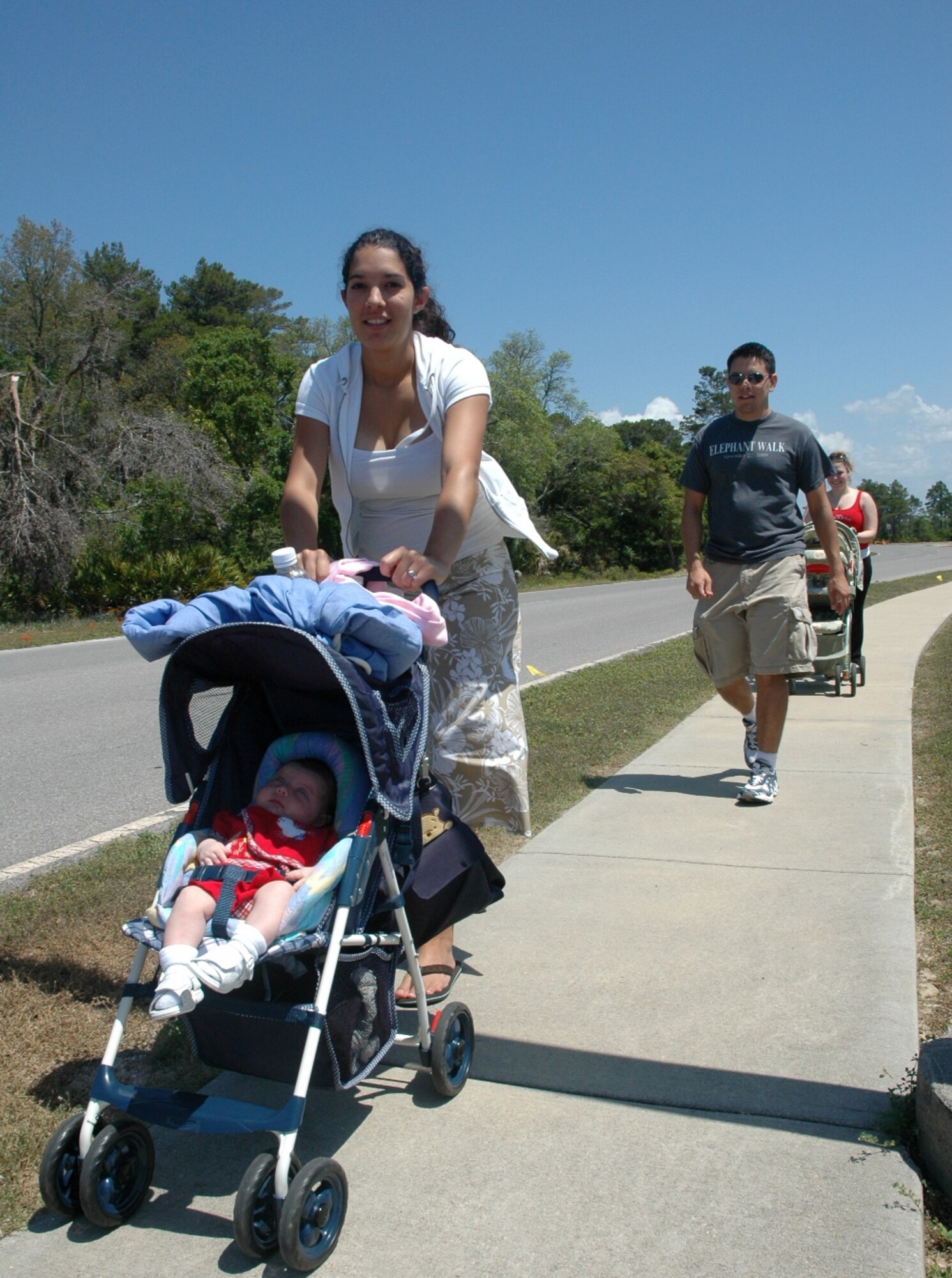 Joy Elizondo and 2nd Lt. David Elizondo, 325th Air Control Squadron student, finish the final stretch of the 5K stroller walk and run at the Youth Center Saturday.  The walk was to raise awareness for child abuse, sexual assault and alcohol awareness as part of the month of the military child.  (U.S. Air Force photo/Staff Sgt. Timothy R. Capling)