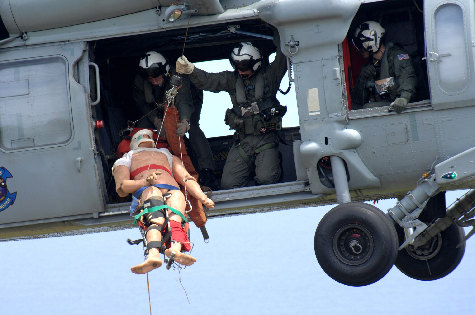 Members from Helicopter Sea Combat 25 perform an airlift rescue at Tarague Beach for a simulated injured hiker during an Initial Readiness Response Exercise April 28. (U.S. Air Force Photo/Senior Airman Sonya Croston)