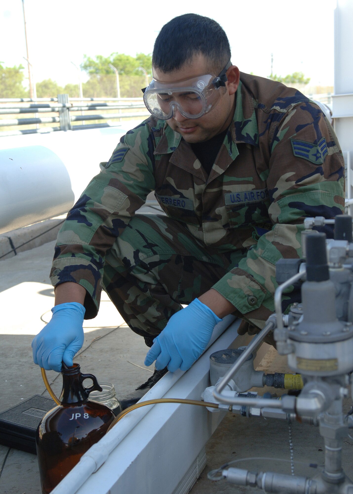 DYESS AIR FORCE BASE, Texas -- Senior Airman Rogelio Guerrero pumps a gallon of JP-8 fuel into a bottle, April 24. The fuel was pumped out to test the amount of sediment left in the fuel. (U.S. Air Force Photo by Airman 1st Class Micheal Breaux)