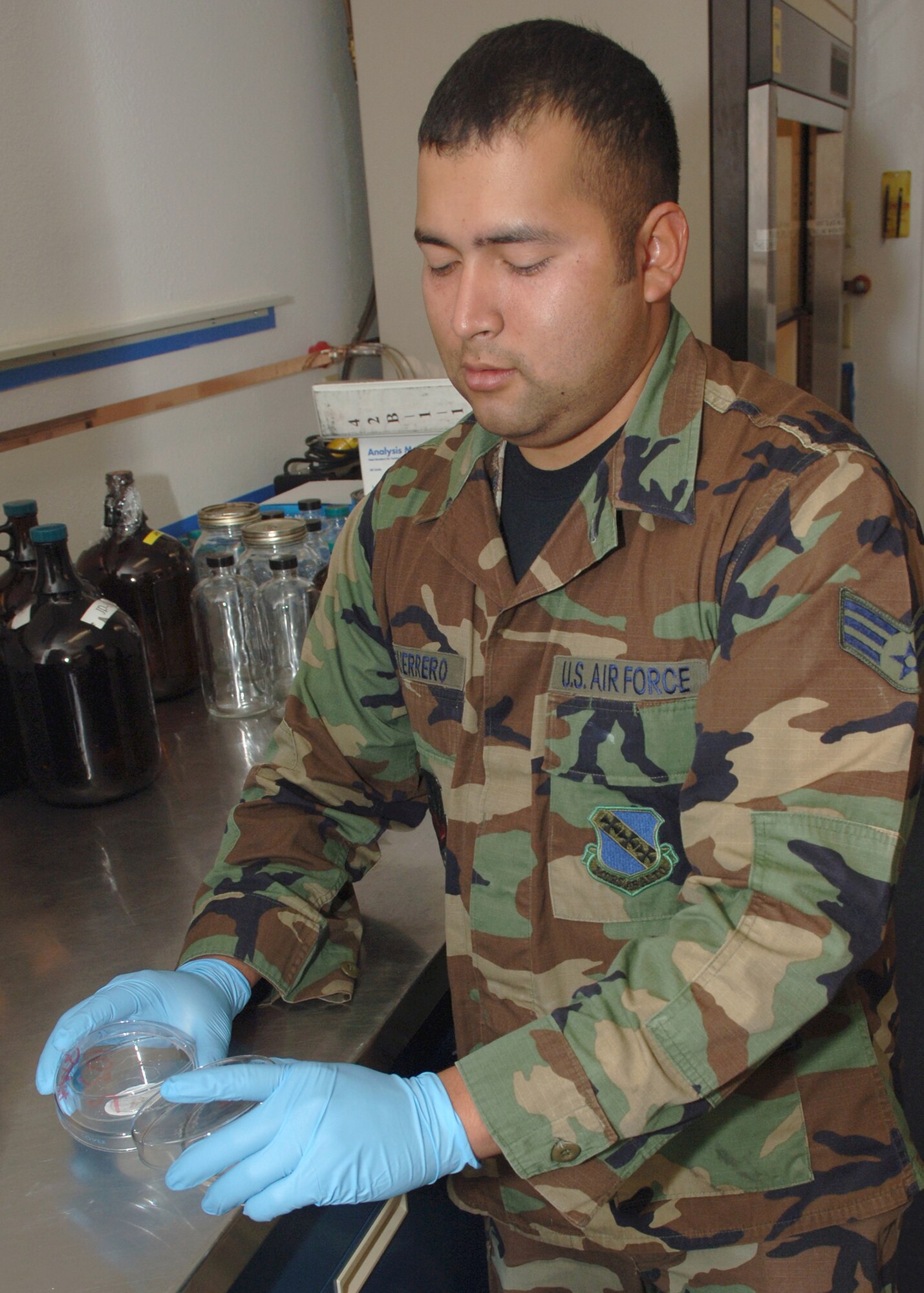 DYESS AIR FORCE BASE, Texas -- Senior Airman Rogelio Guerrero prepares a dish for examination April 24. The filter paper will be tested to see how much sediment was filtered out from a one gallon sample of JP-8 fuel. (U.S. Air Force Photo by Airman 1st Class Micheal Breaux)