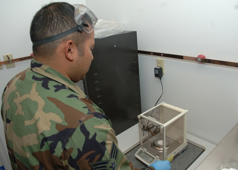 DYESS AIR FORCE BASE, Texas -- Senior Airman Rogelio Guerrero heats up a filter pad April 24. The heated pad is used to test the amount of sediment that is in JP-8 jet fuel. (U.S. Air Force Photo by Airman 1st Class Micheal Breaux)
