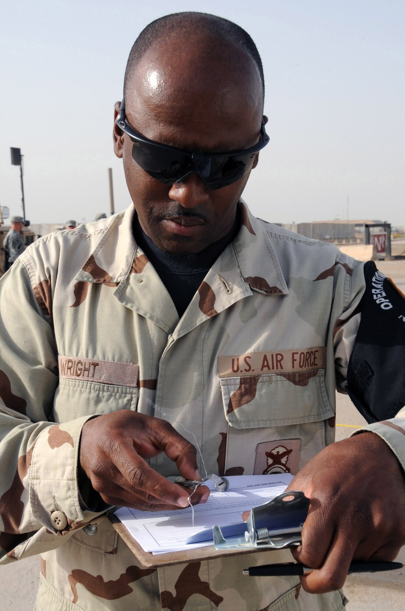 ALI BASE, Iraq - Tech. Sgt. Paul Wright, 407th Provost Marshal's office military police Airman, documents the customs inspection of the U.S. Army 600th Transportation Company prior to their heading home. The Airmen search for contraband items, such as war trophies, and living creatures trying to hitch a free ride back to the United States. Tech. Sgt. Wright is deployed from Spangdahlem AB, Germany (U.S. Air Force photo / Tech. Sgt. Sabrina Johnson) 