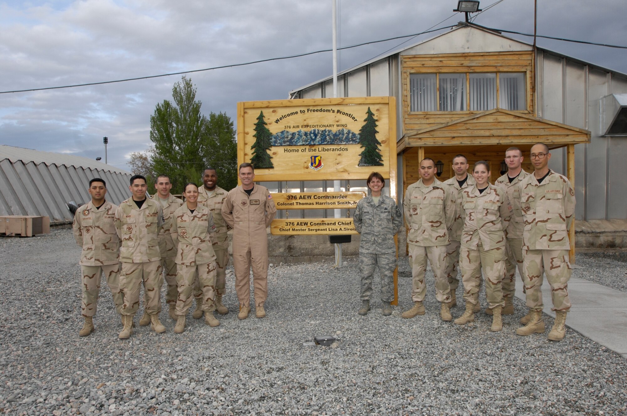 MANAS AB, Kyrgyzstan -- Deployed members from across Electronic Systems Center pose with 376th Air Expeditionary Wing Commander Col. Thomas Harrison Smith, Jr. and Chief Master Sergeant Lisa Sirois, 376 AEW command chief (formerly Electronic Systems Center command chief) April 25 at Manas Air Base, Kyrgyzstan. The ESC members are (left to right) SSgt Carlos Cervantes of the 850th Electronic Systems Group, A1C Sean McKee of the 66th Mission Support Squadron, SrA Tristan J Duff of the Cryptologic Systems Group, SrA Amanda Carter of the 66th Medical Group, SSgt Michael Stephens of the 66th Mission Support Group, A1C Kosal Thim, TSgt Anthony Mello, SrA Krista Schuerhoff, SSgt Damon Farr and SSgt David Tsai, all of the 754 Electronic Systems Group.  More than 170 ESC members are currently deployed around the world. (Courtesy photo)

