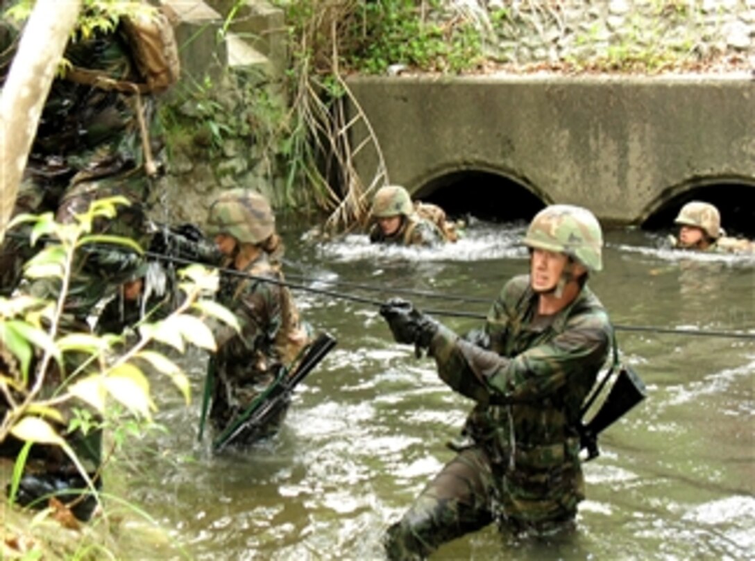 U.S. Navy Seabees assigned to the Naval Mobile Construction Battalion navigate a 3.4-mile endurance course at the U.S. Marine Corps Jungle Warfare Training Center at Camp Gonslaves, Okinawa, Japan, April 25, 2008. The six-day course is designed to refine a unit's patrol and combat skills in a jungle environment and develop small unit leaders. 