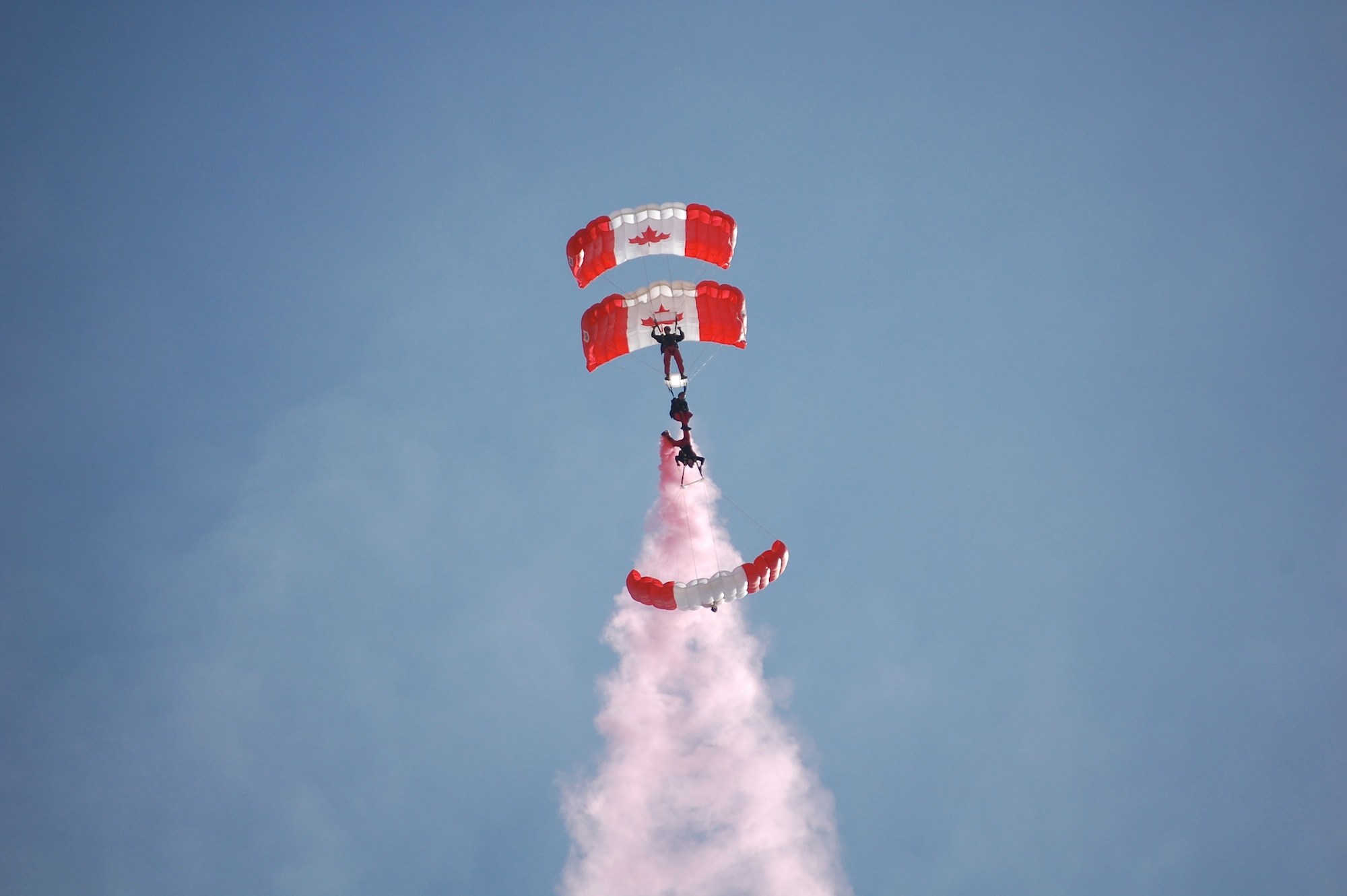 The SkyHawks are a sub-unit of the Canadian Forces Land Advanced Warfare Centre located in Trenton, Ontario. In the team’s 37-year history the Canadian Force Parachute Team – the SkyHawks – have performed around the world to an estimated 70 million spectators under our signature Canadian flag parachutes. This is their Drag formation.
