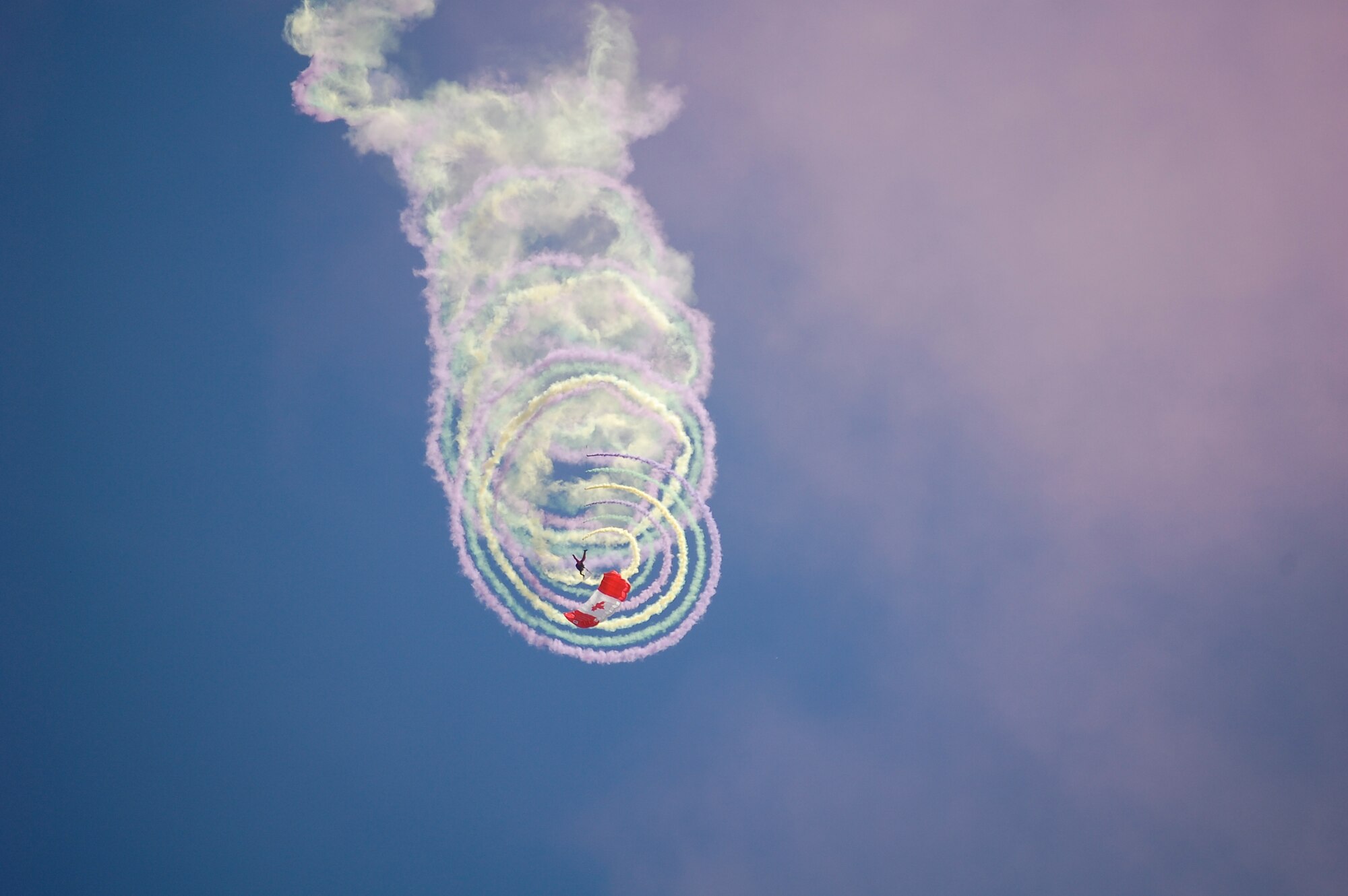 The SkyHawks are a sub-unit of the Canadian Forces Land Advanced Warfare Centre located in Trenton, Ontario. In the team’s 37-year history the Canadian Force Parachute Team – the SkyHawks – have performed around the world to an estimated 70 million spectators under our signature Canadian flag parachutes. This is their Candy Cane formation.
