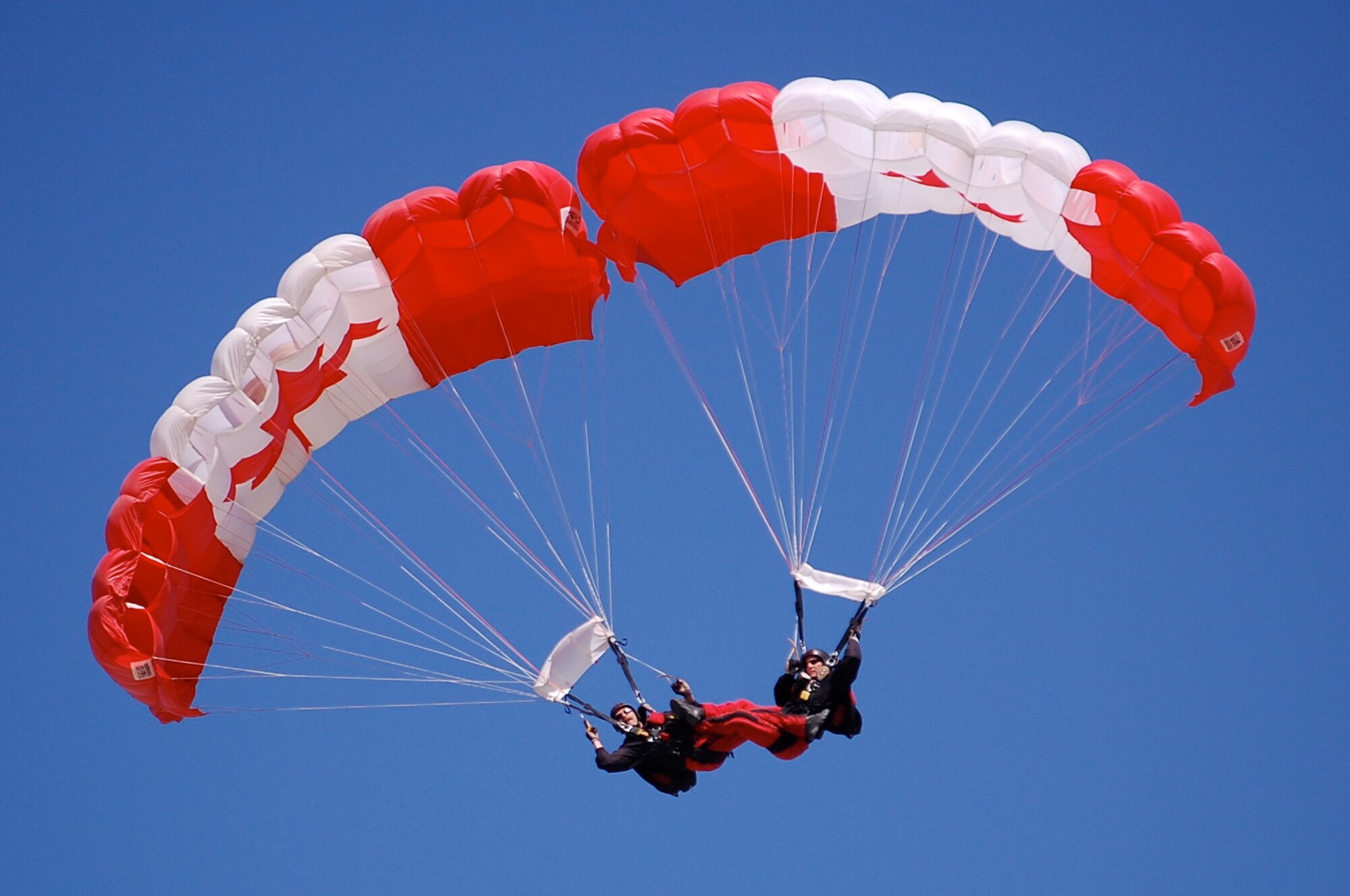 The SkyHawks are a sub-unit of the Canadian Forces Land Advanced Warfare Centre located in Trenton, Ontario. In the team’s 37-year history the Canadian Force Parachute Team – the SkyHawks – have performed around the world to an estimated 70 million spectators under our signature Canadian flag parachutes. This is their parabatic formation.
