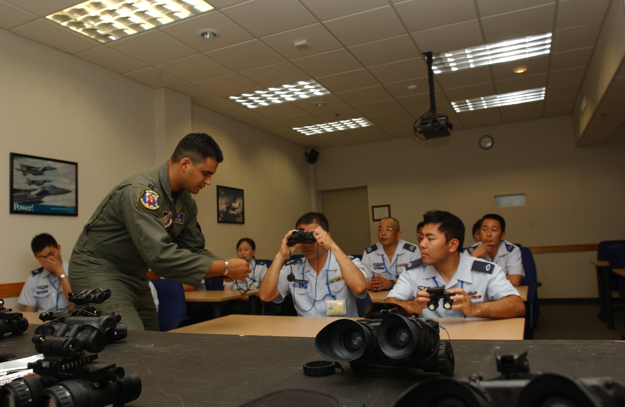 Capt. Alejandro Ramos, 18th Aerospace Medicine Squadron officer in charge
of Aerospace Physiology Operations Element gives a demonstratoin of night
vision technology to Japanese Air Self Defense Force Airmen during a tour of
Kadena April 23.  The tour was part of a bilateral arangment between 5th Air
Force and the government of Japan to offer Airmen from both sides an inside
look at how their counterparts do business.  (U.S. Air Force photo/Senior
Airman Jeremy McGuffin)
